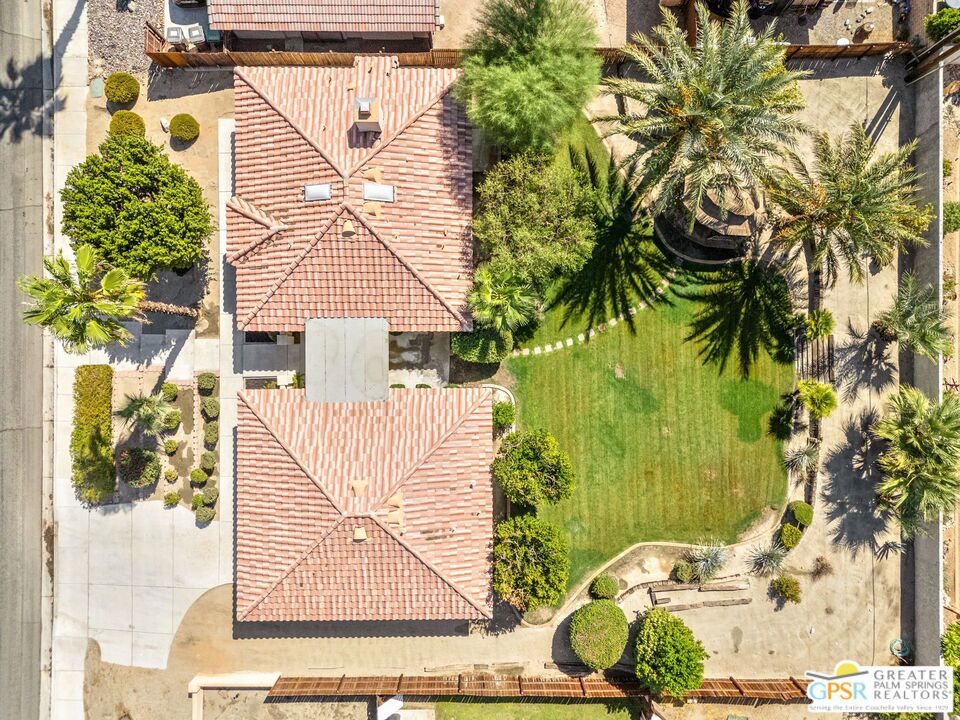 Introducing a custom-built (2002) desert retreat set on a generous 0.29-acre lot, blending striking architecture with modern upgrades and exceptional potential. This 3-bedroom, 3-bath home spans 1,819 sq. ft. and showcases soaring 14-foot pyramid ceilings, new ceramic flooring, fresh paint, updated baseboards, recessed lighting, modern fixtures, and upgraded fireplace tile. The primary suite includes a walk-in closet and a sunken bath, while the second bedroom enjoys its own private bathroom. The guesthouse offers endless possibilities--ideal for a home office, art or music studio, gym, yoga retreat, or guest suit featuring LVP flooring, and a completely remodeled shower. Outdoors, mature landscaping enhances the expansive backyard with fruit trees and a charming gazebo, perfect for entertaining. Zoning and lot size allow for an additional unit, creating significant value for future investment. Close to golf, dining, shopping, and resort amenities. Your desert oasis awaits!