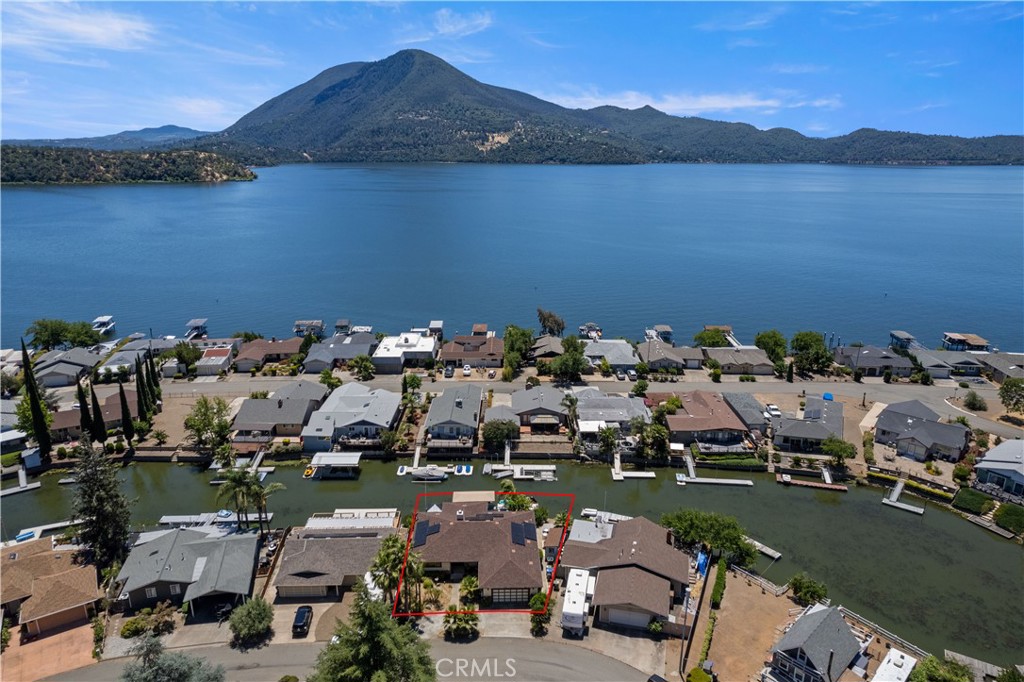Just in time for summer, cast a line right off of your private floating dock in desirable Kona Tayee! Veterans look no more, this is a one of a kind opportunity to assume the current loan at under 3%! This stout true 4 bedroom 3 bathroom home screams summer vacations with family and friends. Step into the formal entry, with primary suite 1 of 2 to your left. Down the hall will lead you to the open living/kitchen area with wood burning fireplace, patio doors, and open kitchen with granite counters and breakfast bar. Off of the living room is the enclosed dining area, perfect for entertaining throughout all seasons. To the right of the living room is the second primary suite, guest bath, and two additional guest bedrooms. All bathrooms offer dual vanities, and shower/tub combo. The interior was just refreshed with all new flooring and paint throughout, updated kitchen appliances, and new walk in shower in master bath. Off of the enclosed patio is the hot tub with concrete pad, and brand new tuff shed for additional storage. The floating dock gives plenty of room for 2 boats to tie up, with an air lift and cover, ideal for winterizing your boat, as well as room for a patio set, and kayak storage. The attached garage is spacious with storage shelves and overhead storage area, laundry, and additional fridge. The home is on Solar, with a payment substantially lower than the PGE bills were. Kono Tayee offers many amenities to its residents; including a private beach, dock, bbq pits and boat rap. Come see what lake living in beautiful Lake County is all about!