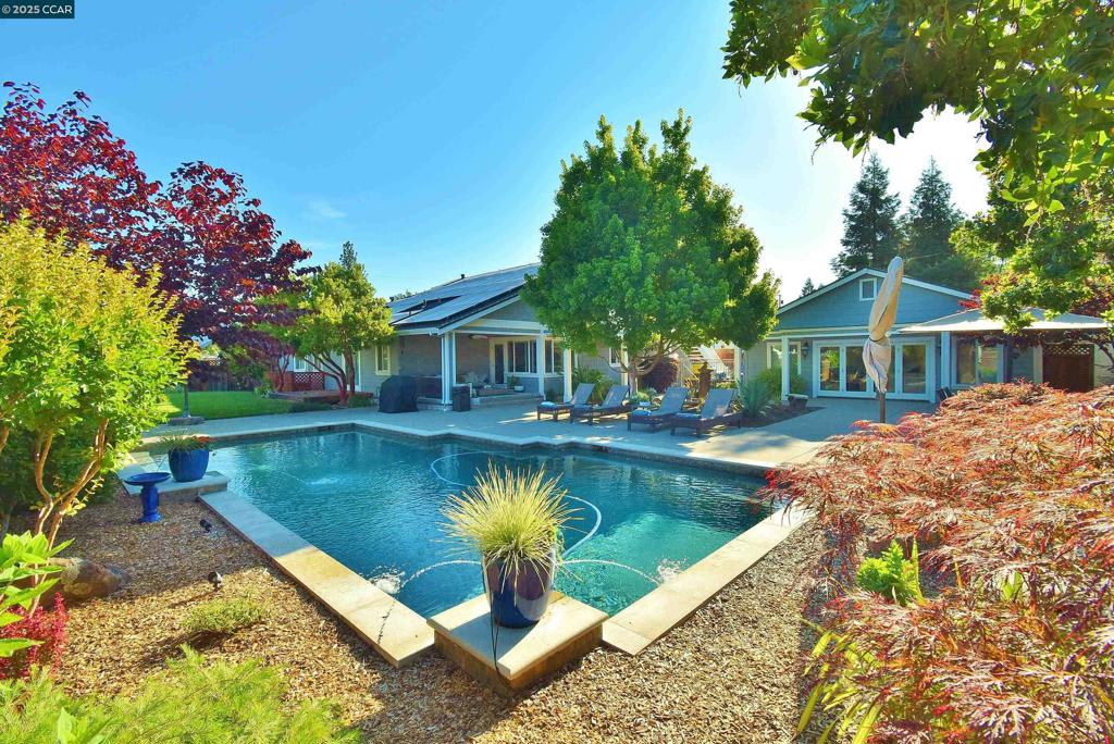 OPEN 8/17 & 8/19, 1PM-5PM! Breathtaking and serene! Boasting over $1 million in luxury upgrades with no detail spared. Two additional dwelling units provide unmatched versatility for multigenerational living. The brand new upstairs one bedroom apartment features a kitchen with island, living room, full bath, custom closet, in-unit washer/dryer, and balcony. The second attached in-law unit has a full bath, kitchenette, and private entrance—ideal for extended family, guests, or a private work space. The cozy great room opens up to the stunningly upgraded kitchen, and features an extended waterfall island, high end Miele appliances, two wine fridges, and top of the line hardware. Perfect for year-round entertaining with a custom bar in the pool house/entertainment lounge and a resort-style backyard with a stunning pool and tranquil areas ideal for unwinding or enjoying peaceful evenings at home. Additional features include: beautiful fireplaces, elegant Knotty Alder wood cabinets, custom closet organizers, owned solar, EV charger, extra long driveway perfect for RV/boat parking and so much more! With so many luxury features and thoughtful details, this home offers far more than can be captured. Steps away shopping and dining in downtown Danville and award winning schools.