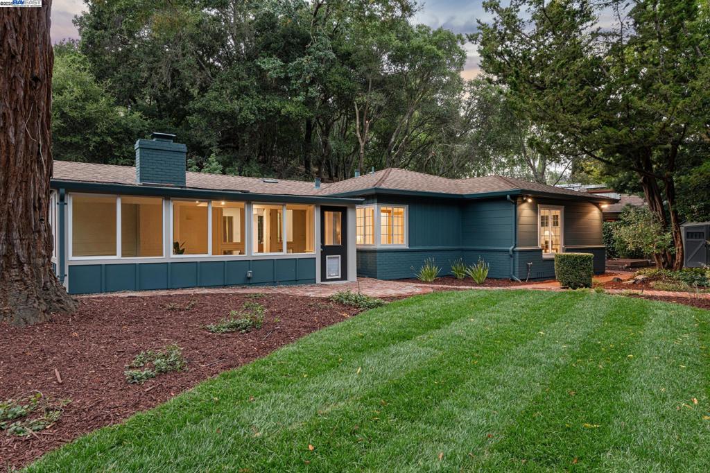 Tucked away on a private cul-de-sac, this beautifully refreshed mid-century gem offers timeless character, modern updates, and extraordinary land. Inside, you'll find a thoughtfully updated kitchen and refreshed bathrooms, along with refinished hardwood floors and fresh interior/exterior paint that enhance the home’s clean, classic aesthetic. The regal great room steals the show with vaulted ceilings, exposed beams, and generous natural light—perfect for entertaining. The flexible floor plan includes 4 bedrooms, 2 bathrooms, an office nook, and an enclosed sunroom, offering space for every lifestyle. Step outside to your own private haven: a sun-drenched deck with new handrails, serene backyard, raised garden beds, and a storage shed, all framed by lush natural surroundings. Set on a sprawling 0.77-acre lot, the property features a private bridge over a tranquil creek, leading to an additional carport and second access from Moraga Way. Whether hosting or unwinding, this home offers an ideal indoor-outdoor experience. Additional highlights include a 1-car garage, proximity to top-rated Orinda schools, and a peaceful setting that feels miles away—yet moments from everything.
