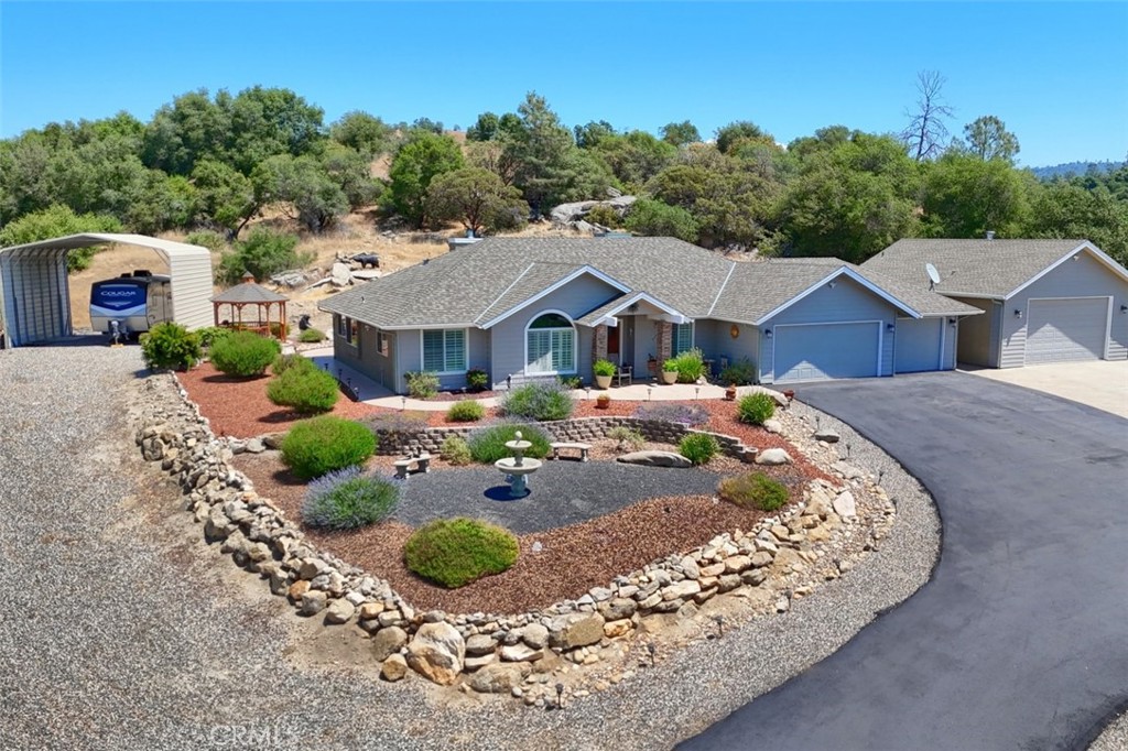Beautiful home in Meadow Springs Ranch w/no HOA & excellent community water system. Fire Wise neighborhood w/Cal Fire station at the entrance & hydrants throughout the community. This single level 4 BD, 2 full BA, 2 half BA w/oversized 5 car garages (1 single, 1-2 car, 1 x-lg. 2 car/shop garage w/half BA-220-2 10 ft. roll-up doors for drive thru) & is ideal for a lg. family. All garages are sheet rocked & have remote openers. Paved RV pad & separate driveway leading to another RV/boat carport. Plenty of room for autos, trucks, toys & hobbies. Custom built 2007 2369+/- sq. ft. home nestled on 2.87+/- acres w/one of the best mountain views & spectacular sunsets in the neighborhood. Fully insulated interior walls & attic, vaulted ceilings, formal front & dining rooms, family room opens to breakfast nook & kitchen w/breakfast bar, granite counters, oak cabinets, microwave, dishwasher, propane cooktop & oven. Primary BD has 2 closets, dbl. sinks, jetted tub & shower. Professionally landscaped yard w/over-sized stamped concrete patio perfect for entertaining & sidewalks surround the home. Low maintenance yard w/native plants, rocks, drip system & storage shed. Engineered hardwood floors & ceiling fan/lights throughout, dual zoned air/heat, alarm system, motion sensor security lights surround exterior, recessed lighting, wood shutters, fireplace w/insert, back-up generator ready, owned 500 gal. propane tank, Rinnai tankless water heater plus newly repaved driveway. Must see!