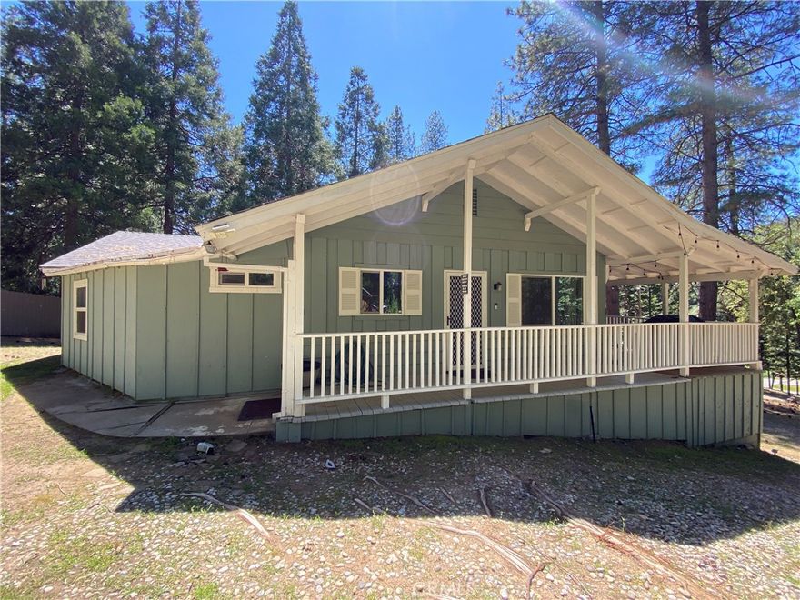 Live among the pines in this picturesque mountain cabin conveniently located in the Cedar Valley community just off of Highway 41. Ascend the stairs to find a large covered deck, perfect for barbecues and enjoying time with friends outdoors. Don't let the exterior original cabin feel fool you, this home has been beautifully updated with laminate flooring, granite countertops, updated recessed lighting, newer appliances and newer paint throughout. Entertain your guests at the large kitchen island equipped with bar seating. Through the hallway you'll find your laundry area and 2 bedrooms each with their own bathroom. Each bathroom has recently installed walk-in tile showers and granite countertops. Off the main living area you'll find a guest bathroom with a tub/shower combo and 2 additional bedrooms for guests. Plenty of parking available and a covered carport area for your toys, tools or workshop. Located close to Oakhurst shopping and amenities and approximately 20 minutes to the south entrance into Yosemite National Park. Call this your home today!