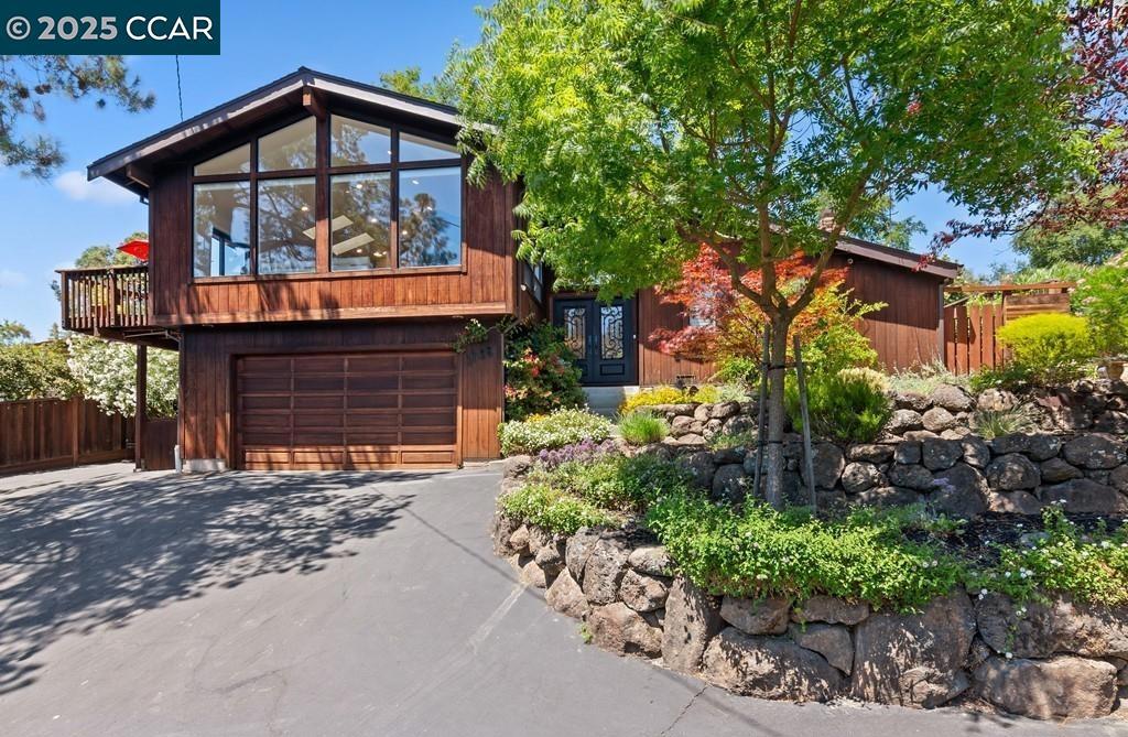Tucked on a private lane in one of Lafayette’s most beloved neighborhoods & walking distance to vibrant downtown with local favorites, this beautifully updated home is the perfect blend of charm, privacy, & convenience. Thoughtfully crafted with quality details throughout, including classic redwood siding, warm oak hardwood floors, vaulted ceilings, & expansive windows & glass doors that fill the interiors with natural light. There are views of the rolling hills, & pretty outlooks from each space. The stylishly renovated kitchen & baths offer modern comfort. The versatile floor plan includes two wonderful living spaces, a large dining room with a wall of glass to the backyard, & a lovely primary suite with a sleek contemporary bath & spacious walk-in closet plus a second ensuite with stunning Carrara bath. This is true California outdoor living with a serene, beautifully landscaped backyard sanctuary complete with a newer deck, large paver patio, veggie garden, grape vines, & flowering pathways that invite year-round enjoyment. Mature trees, bougainvillea, & blooming perennials create a peaceful, garden like setting. Additional highlights include owned solar, Tesla Powerwall + easy access to top-rated Lafayette schools, including Happy Valley Elementary (1.7 mi) & commute.