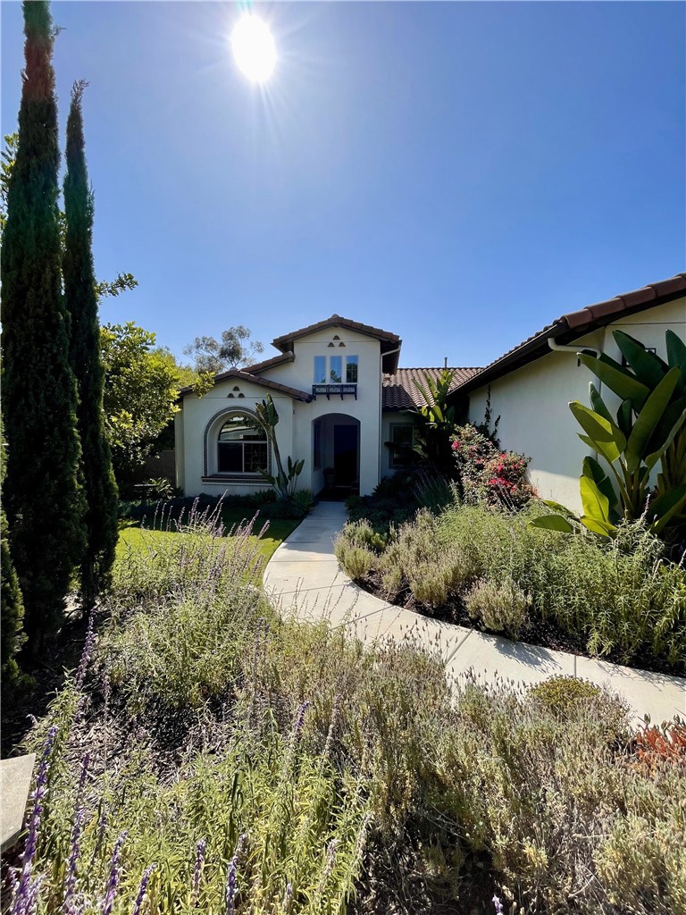This stunning single-story home nestled in Fullerton's prestigious LAGUNA ESTATES community. Built in 2016 by Keusder Homes, this privately gated residence offers 3,830 sq ft of luxurious living space on nearly half an acre, beautifully perched above the scenic Juanita Creek Trail. Step inside to discover an expansive open floor plan featuring 3 bedrooms and 3.5 baths. The heart of this home is the chef-grade kitchen, complete with quartz countertops, full subway-tile backsplash, KitchenAid stainless appliances—including a 48" commercial range and prep sink—and an oversized island perfect for casual gatherings. The adjacent great room, with its gas fireplace and La Cantina-style doors, seamlessly flows to a California room ideal for entertaining. The generously sized primary suite impresses with double vanities, a spa-like walk-in shower, free-standing tub, and spacious walk-in closet. Additional interior highlights include a formal living room, dining room, a music/media room, Nest smart controls, built-in sound system wiring, 9'+ ceilings, and classic finishes throughout. Outside, the drought-resistant landscaping enhances curb appeal, while the backyard offers a canyon view and room to add a pool. The oversized 3-car garage provides ample space and storage. With energy-efficient windows, a low-maintenance yard, and top-rated schools nearby, Laguna Road Elementary, D. Russell Parks Junior High, and Sunny Hills High. This home perfectly blends elegance, comfort, and lifestyle. Don't miss this rare opportunity to own a turnkey, single-story luxury home in one of Fullerton’s most sought-after neighborhoods.