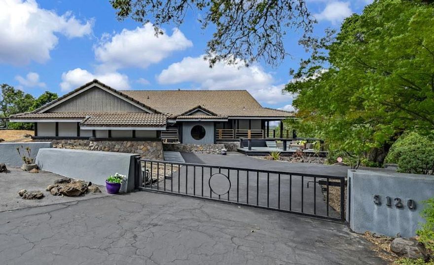 Nestled on a private road near North Sonoma Mountain State Park, this custom-built home has views of the valley and Taylor Mountain. On approx 3 acres, this 2,368 sq ft, three-bedroom, two-bath home has an Asian feel. A large eat-in kitchen and living room with vaulted ceilings and a spectacular floor-to-ceiling stone fireplace. Most of the rooms are open to the outside, with an LG deck covering 3/4 of the home. The deck is made with durable imported wood. The master is quite large with access to a deck, and cedar-lined closet &  a bonus room behind it. The ma bath is also very large with a walk-in shower, double sink, separate toilet, a closet, and room for more. One of the most unique concepts about the home is that there are no gutters, when it rains, the rain falls into troughs built around the home to create a water feature. There is a large two-car carport, and the basement has a storage room and space for more. The low monthly dues of $349.50 include water but may vary on usage