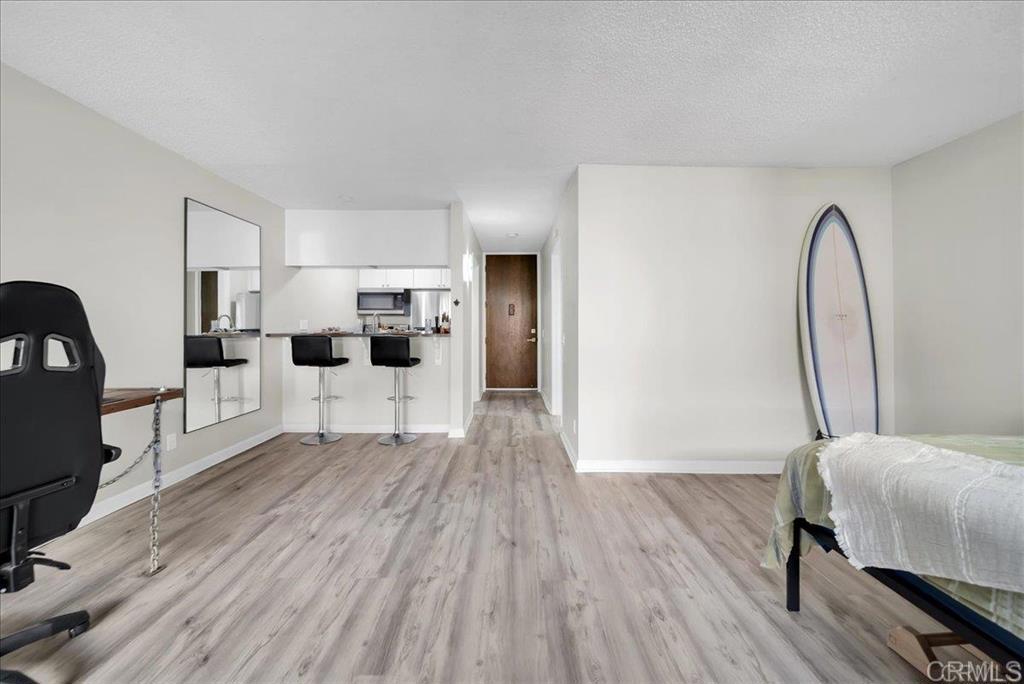 Open House (Sat & Sun) Sept 6th & 7th (Noon-3PM) Discover modern elegance in this beautifully remodeled top-floor studio condo at 6202 Friars Rd, San Diego, CA 92108. Nestled in the heart of vibrant Fashion Valley, this open-concept gem boasts a fresh, contemporary design with premium upgrades throughout. Step inside to find sleek white shaker cabinets paired with sparkling quartz countertops in the kitchen, creating a bright and inviting space. The bathroom shines with a quartz-topped vanity and a recently refinished tub/shower combo. Recently painted walls and stylish new luxury vinyl plank flooring elevate the aesthetic, while a brand-new AC and heating unit ensure year-round comfort. Thoughtful details include mirrored closet doors and built-in closet drawers for ample storage. Enjoy the convenience of on-site laundry facilities and the security of an assigned parking spot in the gated garage. The Bluffs community offers an exceptional lifestyle with resort-style amenities: take a dip in the sparkling pools, unwind in the spa or sauna, stay active in the fitness center, or enjoy a match on the tennis courts. Host gatherings at the BBQ patio or relax in the clubhouse. Plus, benefit from included utilities like water, sewer, and basic cable! Perfectly located, this condo puts you minutes from San Diego’s best dining, shopping, and entertainment in Fashion Valley and beyond. Enjoy the coastal lifestyle with Mission Bay, SeaWorld, and San Diego’s pristine beaches just a short drive, offering endless opportunities for outdoor adventures and relaxation. Don’t miss your chance to own this move-in-ready studio that blends modern luxury with unbeatable convenience!