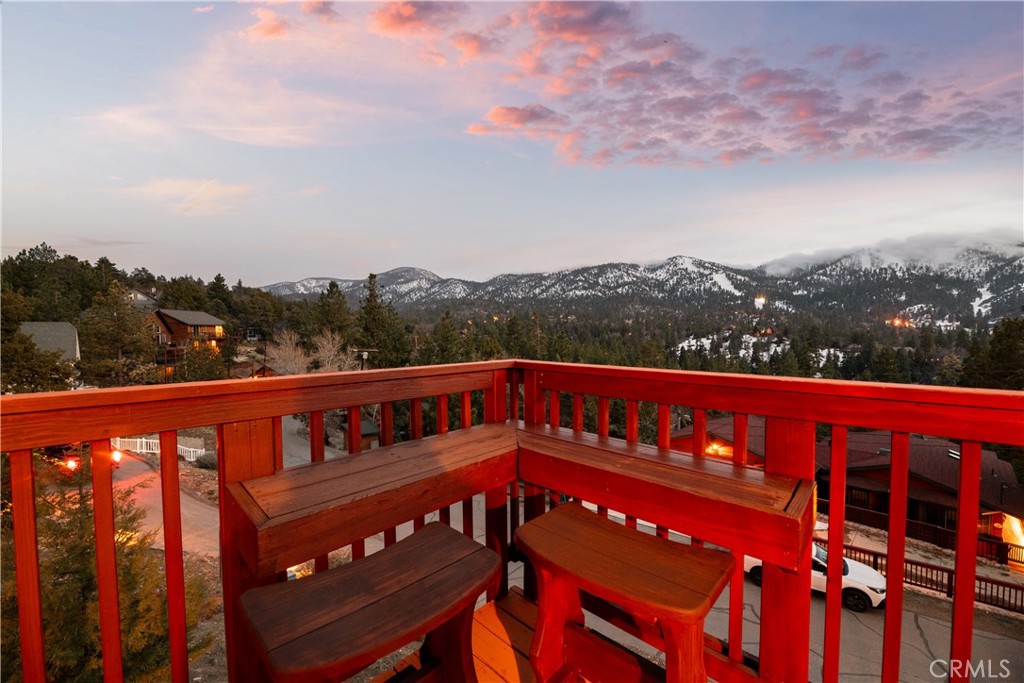 Don’t miss these panoramic mountain and ski slope views in Moonridge! This fully renovated mountain retreat offers breathtaking 180-degree vistas of Bear Mountain Ski Resort, the surrounding mountains, and the National Forest. Taken down to the studs and completely rebuilt in 2016—along with the addition of an oversized two-car garage—this home blends modern comfort with timeless mountain charm. Inside, you’ll find warm tongue-and-groove walls and ceilings, expansive windows that flood the space with natural light and frame the incredible scenery, plus fresh paint and brand-new laminate flooring throughout. The beautifully remodeled kitchen showcases granite countertops, Knotty Alder cabinetry, and stainless steel appliances. The open-concept great room combines the kitchen, dining area, and two spacious living areas, all designed for comfort and to highlight the views. Step out onto the large deck to take in the year-round scenery or relax in the spa while watching skiers carve down the mountain. The fenced yard offers space for pets, kids, or outdoor fun, while the oversized garage provides ample storage for mountain toys, an EV charging station, and room for gear. Additional seller improvements include freshly stained log siding (2023) and a new roof (2018). With 3 bedrooms, 2.5 bathrooms, and a prime location just minutes from ski resorts, golf, and hiking trails, this property is a true mountain gem—and one not to be missed.