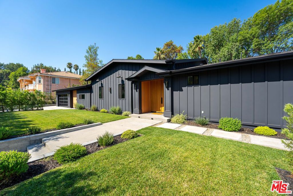 Beautifully updated single-story modern farmhouse located south of the boulevard in coveted Vista De Oro. This spacious home offers high ceilings, wide plank wood floors, and abundant natural light throughout. The open-concept layout features a chef's kitchen with a large center island, quartz countertops, custom cabinetry, and premium appliances, perfect for both everyday living and entertaining.The primary suite opens directly to the backyard and boasts a spa-like bath with soaking tub, oversized shower, and a boutique-style walk-in closet. Three additional bedrooms each include their own en-suite bathrooms for comfort and privacy.The private backyard is an entertainer's dream with a newly updated pool, sport court, and multiple areas for lounging or dining outdoors. Close to top-rated schools, shops, and restaurants.