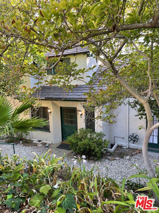 This enchanting English manor in the heart of Lake Hollywood is appointed throughout with original character details preserved to maintain the authenticity of its old world charm & personality. Handsome hardwood floors extend throughout the public spaces which include a grand living room with an impressive truss wood beamed ceiling, elegant towering fireplace and French doors that frame lovely views of the lush landscaping. The formal dining room is adjacent to a sunny eat-in kitchen and laundry area with access to the spacious backyard with ample space to entertain or relax. Downstairs also offers a bedroom or office that overlooks the lush front landscaping via French windows. Upstairs offers two bedrooms and a cheerful sun room with a full tiled bathroom with separate tub and shower. This character rich story book home is available for immediate move in. Contact Listing Agent to schedule an appt.