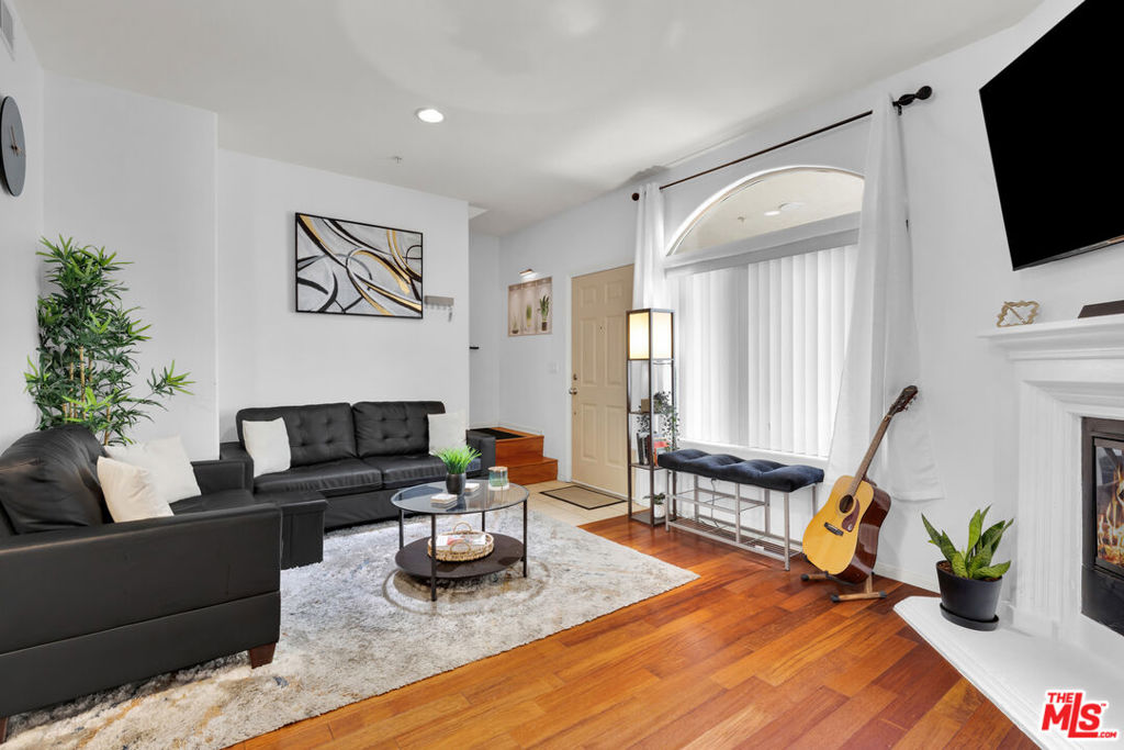 Welcome to this beautifully updated 3 bedroom, 3 bathroom two-story condo located in a newer, well-maintained building with low HOA dues. This thoughtfully designed home features a rare layout with three full bathrooms, providing the convenience of a full bath for every bedroom. The open-concept living area is filled with natural light and features hardwood floors, recessed lighting, and a cozy fireplace that adds warmth and charm. The updated kitchen is finished with granite countertops, stainless steel appliances, and plenty of cabinet space, combining style and function. Upstairs, you'll find spacious bedrooms including a primary suite with its own bathroom and generous closet space. Additional highlights include in-unit laundry with a full-size washer and dryer, central air and heat, and two reserved parking spaces in a secure garage. The gated community also offers a shared BBQ and patio area, and is conveniently located near shopping, dining, parks, and major commuter routes. This move-in ready condo blends modern updates with a practical layout in a prime location.