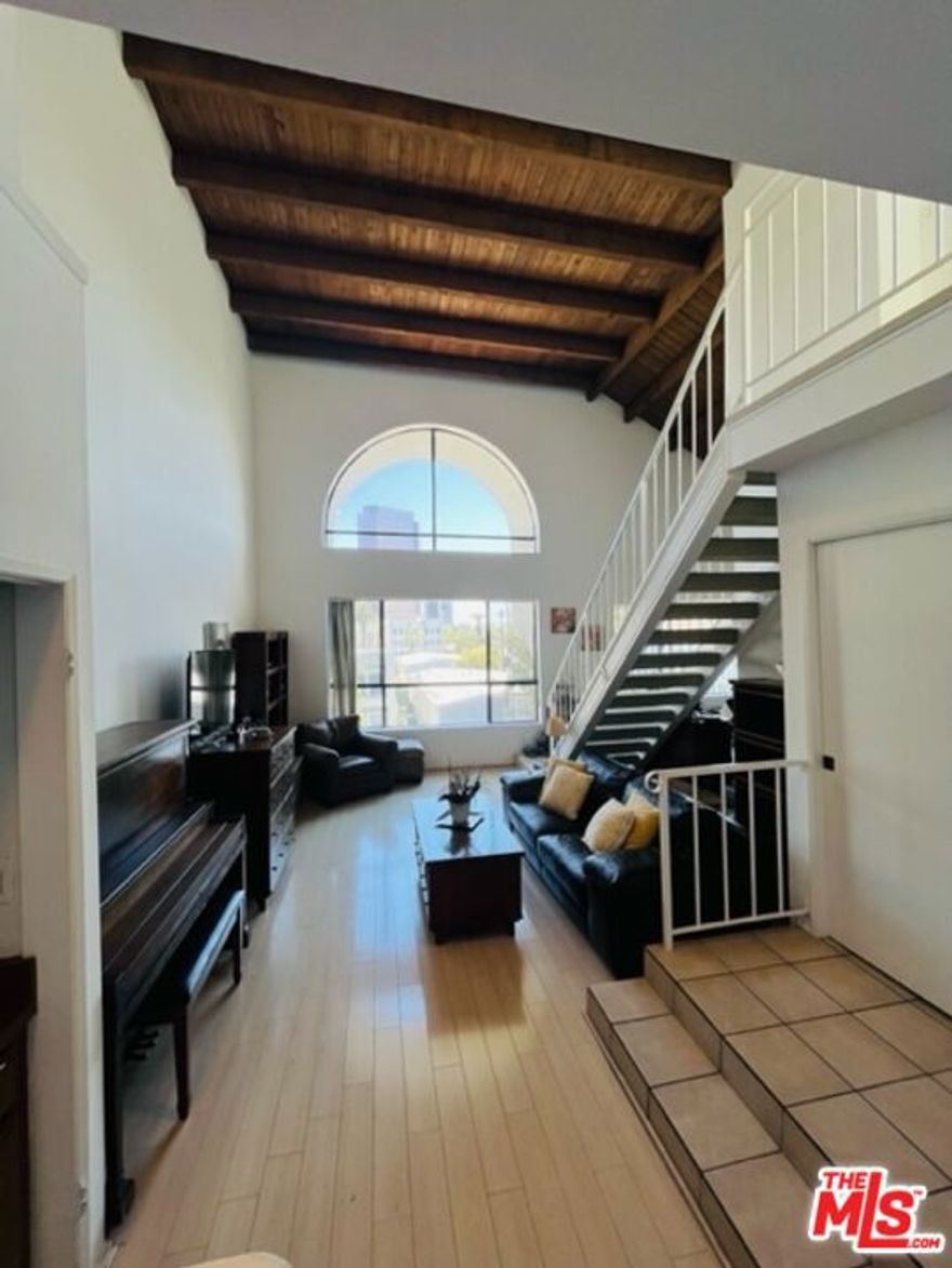Beautiful bright top floor penthouse two story condominium unit with high ceilings in prime Beverly Hills.  Master bedroom, 2nd bedroom, two bathrooms, Living, Dining room, & Kitchen on the first floor.  Stairs lead up to 2nd floor where the hallway leads to private spacious outdoor patio and also the 3rd bedroom/or office.  Feels like a single family home.  Washer/Dryer in the unit.  Central A/C & Heat.  Building amenities include outdoor pool, elevator.  Two car tandem underground gated parking.  Great city & street views in living and dining room areas.  Located less then a block away from the Beverly Hills La Cienega Park and minutes to the Beverly Center, Rodeo Drive, The Grove, L.A.C.M.A, & other Museums.  Close to houses of worship.  Unit can also be delivered mostly furnished for an additional $500 per month.