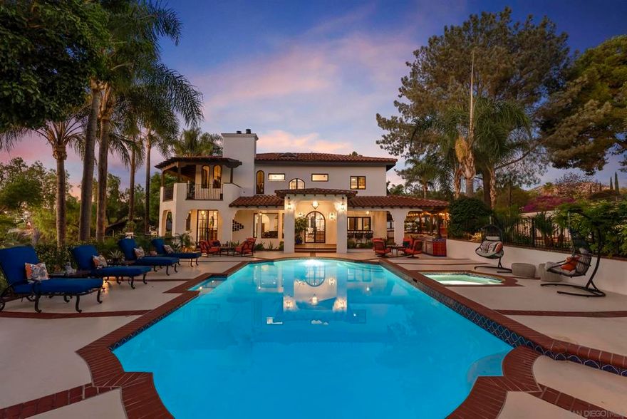 This Granite Hills authentic Spanish Hacienda is a work of art. The home has been completely remodeled from top to bottom with custom iron doors, hand painted Spanish tile throughout, walnut cabinets, top of the line appliances, new HVAC system, new stucco, outdoor kitchen, wraparound decks, and a wine closet. With RV parking, an attached 2 car garage + detached 4 car garage, and standalone workshop, there's plenty of room for a multitude of cars, boats, and desert toys. The home also includes a detached two-bedroom new guest house with its own parking and entrance, perfect for rental income or multi-generational living. This fully-fenced property is truly an oasis. With ample grounds to entertain and relax, this home is not to be missed!