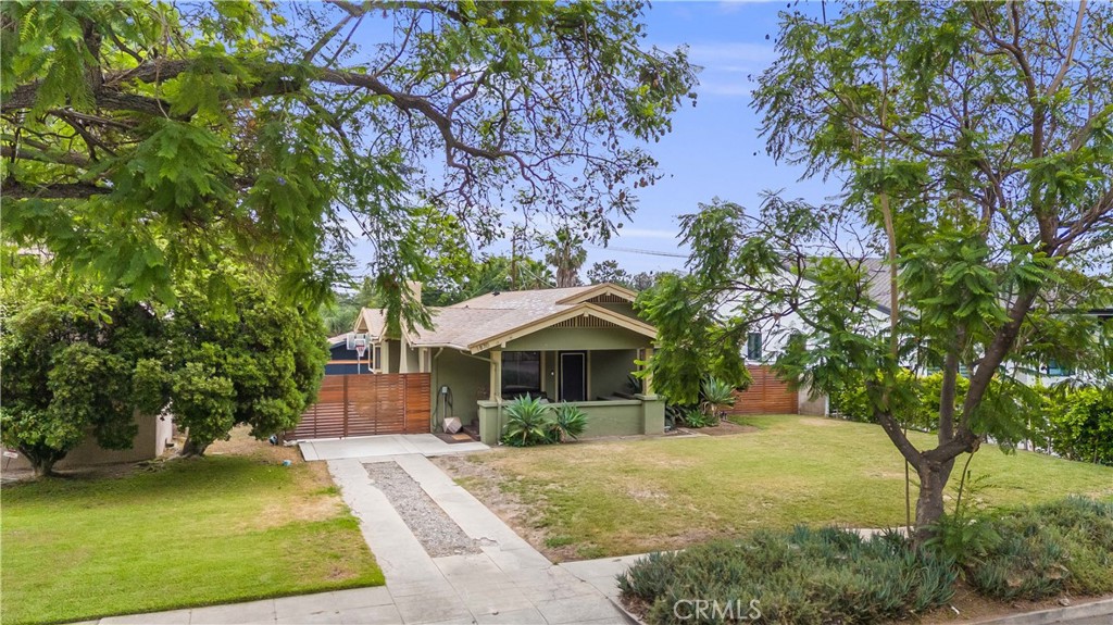 Stunning craftsman in one of Northeast Pasadena's most sought-after neighborhoods. This home in the Landmark district, has sweeping mountain views along with broad, tranquil, tree-lined streets. Built in 1922, this 3 bed 1.5 bath bungalow sits on an expansive 10,558 sq. ft lot. Upon entry, you will find a nice blend of vintage charm with modern upgrades. You are greeted with exposed beams, built-in shelving and clean lines. The living room flows naturally into the dining room and open-concept kitchen. Past the hallways are 3 ample sized bedrooms, an updated full bath with separate tub, and a stylish powder room. Parking is made easy with an oversized front driveway in addition to a separate stall accessible through the rear alley. The detached garage with custom flooring can be used as a home office, home gym or any flexible space that suits your needs. Stepping outside, the backyard is primed for entertaining. Whether it's doing yoga on the turf or sun-bathing on the hammock, there are multiple areas for retreat. All four corners of the yard are surrounded by mature ficus hedges and trees offering complete privacy. With all that said, there is still ample space to build a pool or ADU. The house is also equipped with solar paneling and 220V plug for EV charging. The possibilities here are endless. All this is just moments from Victory Park, the charm of Old Town Pasadena, Rose Bowl, and some of the best private schools in the area.