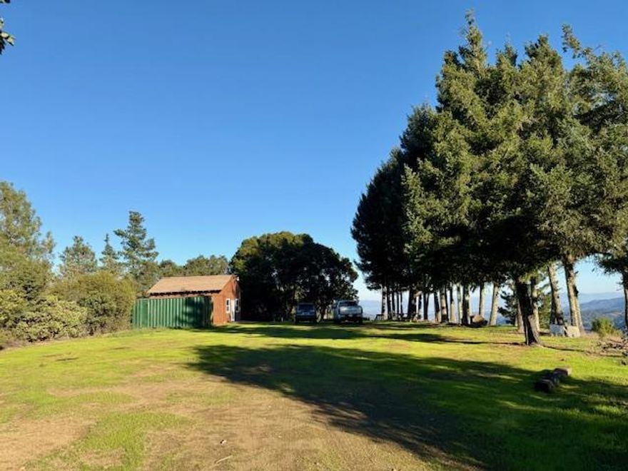 35 ACRE TRUE DREAM! REDWOOD ESCAPE AND RETREAT! MANY STRUCTURES! DO WHAT YOUR HEART DESIRES IN THIS INCREDIBLE COMPLEX! RENTALS? FAMILY COMPLEX? SHOOTING RANGE! HIKE FOREVER! YOGA RETREAT! ATVS! ANYTHING YOU CAN IMAGINE! The redwood forest feels like it never ends. There is an approx 4 acre private cleared pad separated from the rest of the property ready to be developed surrounded by a nut orchard! The strongest spring I have ever seen on a property with a fully developed water system throughout the entire property and spigots everywhere. Million dollar views. Literally the most panoramic incredible views from the main structure and pad. No PGE but 100 amp box with generator (included) to power main house. Many metal structures, wall heater, stained glass windows, endless structures,  woodworking area, palm trees, an old 5th wheel. DOZENS OF PADS! A mix of paved access, gravel, dirt and 4 wheel drive in winter shared access driveway. Have your Realtor contact me for property videos. 2,500 gallon water tank. Seasonal Creek. From the center of Watsonville Road and Redwood Retreat Road it is 5.3 miles and took 13 minutes to arrive at the access driveway leading to this property.