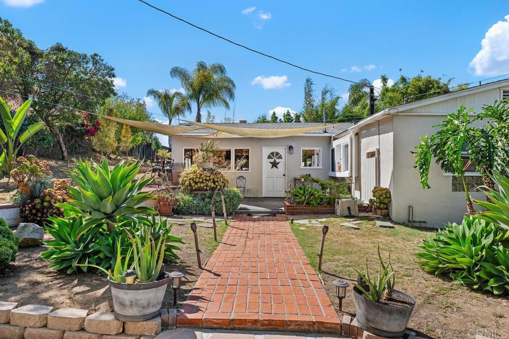 Welcome home to this Charming 1940s split-level rancher set on a large, private lot in a desirable Vista neighborhood. Tucked off the street for added privacy, this light and bright home offers an open floor plan perfect for entertaining, featuring engineered wood flooring, a cozy wood-burning fireplace, and a country-style kitchen with modern appliances. Recent upgrades include new PEX plumbing, some electrical improvements, and updates to both the master and basement bathrooms. The finished basement adds approximately 544 sq ft of flexible living space, NOT included in the homes 1,338 sq ft. of living space. It is ideal for a home office, gym, or guest suite. Situated on just under ½ an acre,(.37) the property boasts improved landscaping, a designated garden area, a cozy firepit zone, and a variety of fruit trees including avocado, citrus, persimmon, and grapevine. Two adjacent shops plus a large finished garage/workshop with electric and offer incredible potential for a home business, or creative studio. This property has a lot of room for a future ADU as well. Tons of storage, mature trees, and endless potential make this a rare opportunity in the heart of Vista. Sewer connected. No HOA or Mello-Roos.