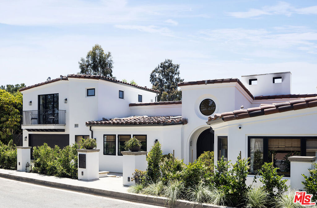 Nestled among lush trees on a serene cul-de-sac just north of Sunset Blvd, this stunning Contemporary Mediterranean home offers seclusion and breathtaking views. With 4 bedrooms and 5 baths, it features an airy open layout with hardwood floors and expansive windows flooding the space with natural light. Perfect for entertaining, the living room boasts a cozy wood-burning fireplace, while the expansive yard offers a spacious patio for outdoor dining. The chef's kitchen, with custom cabinetry, is a culinary haven. The primary suite includes a massive walk-in closet, two luxurious wood tile bathrooms, and access to the tranquil backyard. Situated on over half an acre, this property presents endless opportunities with room for a pool, pickleball court, or guest house. A rare opportunity not to be missed!
