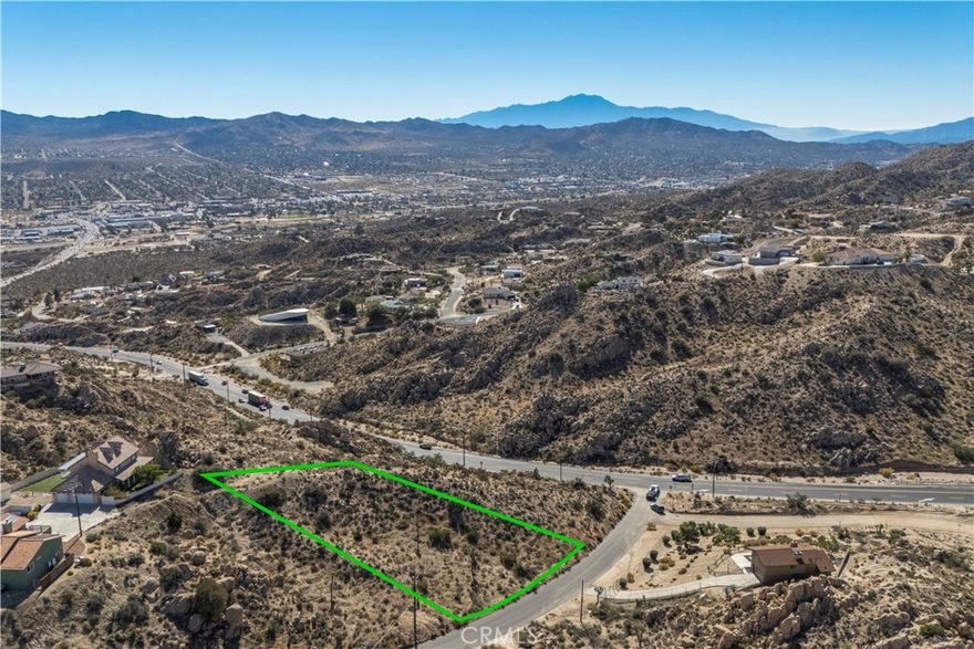 Discover a rare hillside parcel in one of Yucca Valley’s most desirable neighborhoods. This elevated lot offers sweeping panoramic views of the valley, surrounding mountains, and natural rock formations. The property features a beautiful blend of high-desert terrain, including native boulders, mature vegetation, and a natural slope ideal for a view-oriented architectural design.

Surrounded by well-established homes, many valued above $500,000, this parcel provides excellent potential for a custom residence in a sought-after location. Road access is convenient, and utilities appear to be nearby (buyer to verify). The setting offers a balance of privacy and close proximity to town amenities, including shopping, dining, and schools.

This is a rare opportunity to build in a premium Yucca Valley location with exceptional scenery and long-term value. Come explore the property and experience the views that make this area so special.