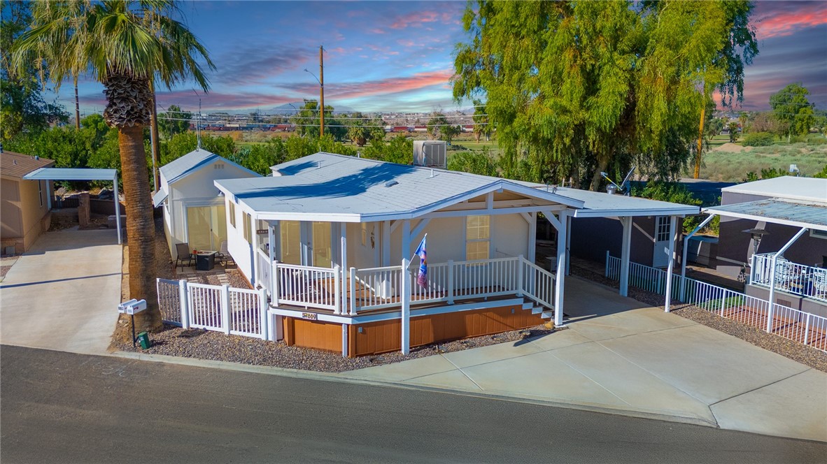 WELCOME to 669 Channel Way* – a RARE OPPORTUNITY to own in the highly sought-after 55+ RIVERFRONT COMMUNITY of The Palms at Verde Shores! This TURNKEY GEM is arguably the NEWEST and MOST UPDATED home in the park and delivers the ultimate in river living with 2 bedrooms, 2 full baths, PLUS an ADDITIONAL 300 sq. ft. CASITA with a PRIVATE ENTRANCE – perfect for guests or a hobby retreat. This property is loaded with OVER $35,000 in upgrades and a reconfigured floor plan designed to maximize both space and functionality. Features also include NEWER INTERIOR PAINT, NEWLY PAINTED CABINETRY, BEAUTIFUL LUXURY VINYL PLANK FLOORING, CROWN MOLDING, WOOD CASED WINDOWS AND DOORS, LED lighting with DIMMERS, newer CEILING FANS and 4 energy-efficient MINI SPLITS that allow for ZONE-CONTROLLED COOLING, keeping you comfortable while saving on energy costs. This homes TANKLESS WATER HEATER and RING SECURITY CAMERA provide added convenience and peace of mind. Enjoy stunning mountain views from your elevated front porch, finished with durable TREX DECKING that offers long-lasting, low-maintenance enjoyment. The exterior features NEW WHITE VINYL FENCING, decorative RIVER ROCK LANDSCAPING, and inviting outdoor living spaces. A private walkway leads to the separate 1 bed, 1 bath CASITA, complete with its own kitchenette, mini split system, and additional storage—ideal for hosting guests, accommodating extended family, or generating short-term rental income. A 35+ ft COVERED CARPORT offers highly coveted space for boats, off-road vehicles, and golf carts – because here, your river toys deserve a home too! The community offers exceptional amenities, including extra space STORAGE FACILITY, private FISHING LAGOONS, RIVERFRONT BEACHES, TWO BOAT LAUNCH RAMPS, and a COURTESY DOCK, ensuring you always have direct access to the river without the crowds! Want to unwind? Take a golf cart ride to the nearby course or host a BBQ at Jack Smith community park featuring an exercise loop and playground. This lifestyle is one of the most affordable and enjoyable ways to live along the Colorado River. Last but not least***FIRST YEAR LAND LEASE PAID by seller with ***FULL PRICE OFFER*** making your move even easier and affordable! Whether you're looking for a vacation escape or a forever home, this is your opportunity to make it a reality! Schedule your private showing today!