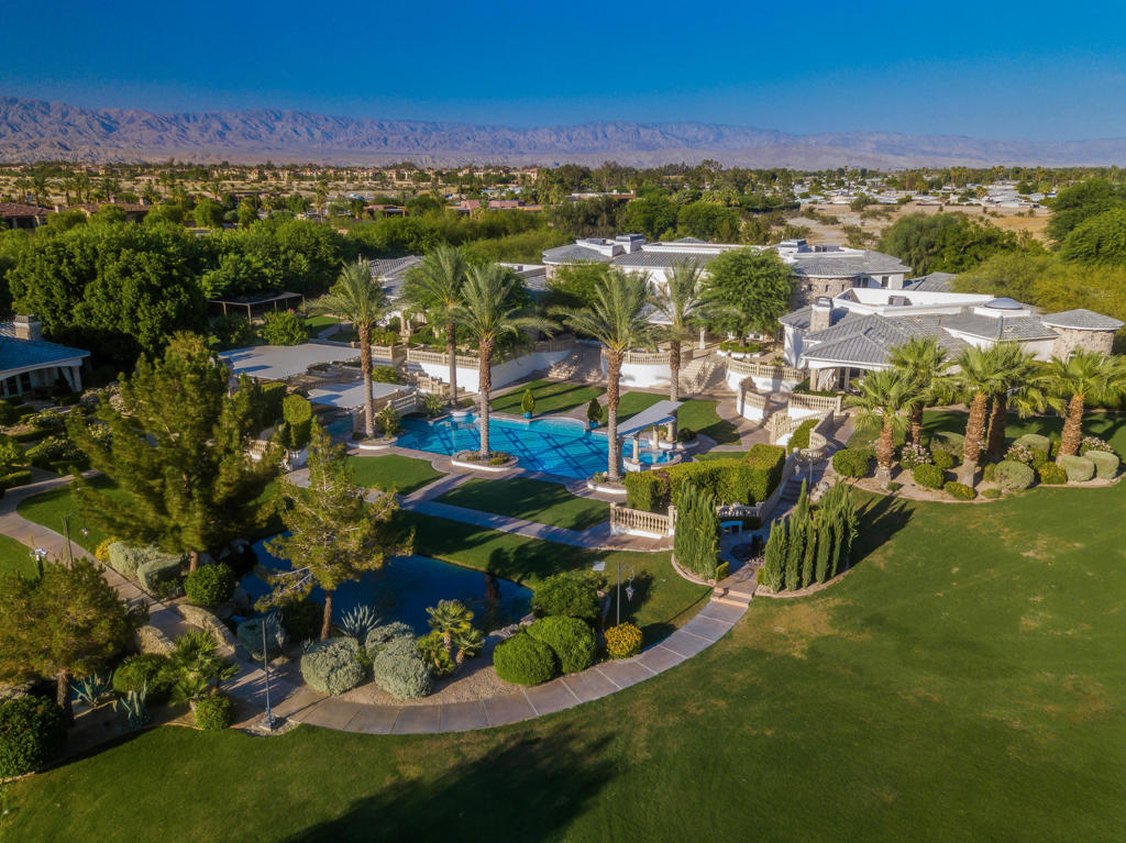 One of a kind resort-like compound! A true family sanctuary in the heart of Rancho Mirage. Privately gated and situated on almost five acres with spectacular views of mountains, lake, gardens and tennis court. Seven bedrooms, seven baths plus two powder rooms including a two bedroom two bath guest house. Approx. 17,870 sq. ft. of pure luxury including double gated drive around beautiful lake and porte-cochere entry. Grand great room, game area, gourmet kitchen, and service kitchen. Formal dining room, wine tasting room, family room with step down bar and beautiful home theatre plus gym. The master retreat hosts a sitting area with fireplace, and built-in office area. The master bath is fit for a queen with private sauna, indoor spa and steam room. The guest accommodations are top notch with private suites and a full guest house. This home was designed to host elaborate events of any kind with French doors opening to a large terrace with central fountain that's overlooking the resort like pool, spa and lake with waterfalls. A full outdoor kitchen and BBQ area with dining and fireplace sits above the other side of the pool. The back lake is awesome with view pavilion and adjacent tennis court and basket balls courts. This is a smart home with off the grid power systems, private well and state of the art security system. Must see to truly appreciate the beauty and grandeur of this one of a kind masterpiece!