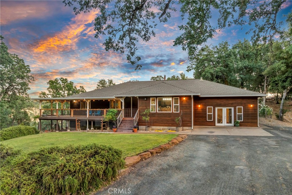 Country Living in the peaceful Hidden Valley Ranchos! This spacious 3-bedroom, 2-bathroom home features a dedicated office and a generous 20x14 bonus room—offering flexible living for families, hobbyists, or work-from-home lifestyles. Tucked away on nearly 7 serene acres, this inviting home boasts an open floor plan with an expansive family room, highlighted by a stunning barrel ceiling and cozy wood-burning stove—perfect for relaxing evenings or entertaining guests.
The heart of the home is the well-appointed kitchen, complete with an island cooktop, breakfast bar, an abundance of cabinetry, full panty and even a built-in desk area for added functionality. The private primary suite is set apart from two comfortable guest rooms and a full guest bath. Step outside onto the wide, wrap-around covered porch to take in breathtaking views of oak-dotted hillsides and enjoy the sounds of the seasonal creek that winds alongside the property. The backyard offers a fenced-in oasis with a nearly new above-ground pool for cooling off on hot summer days, lush lawn front & back, and ample parking—including room for your RV, Boat, Side by Side and more! The handy pumphouse with attached workshop offer additional storage nearby. For those with a green thumb or a love of animals, there’s a fenced garden area with raised beds, a separate fenced livestock zone, and a barn/stable with level pastureland. With thoughtful fire-safe landscaping and a newer roof, this property is ready for its next chapter!