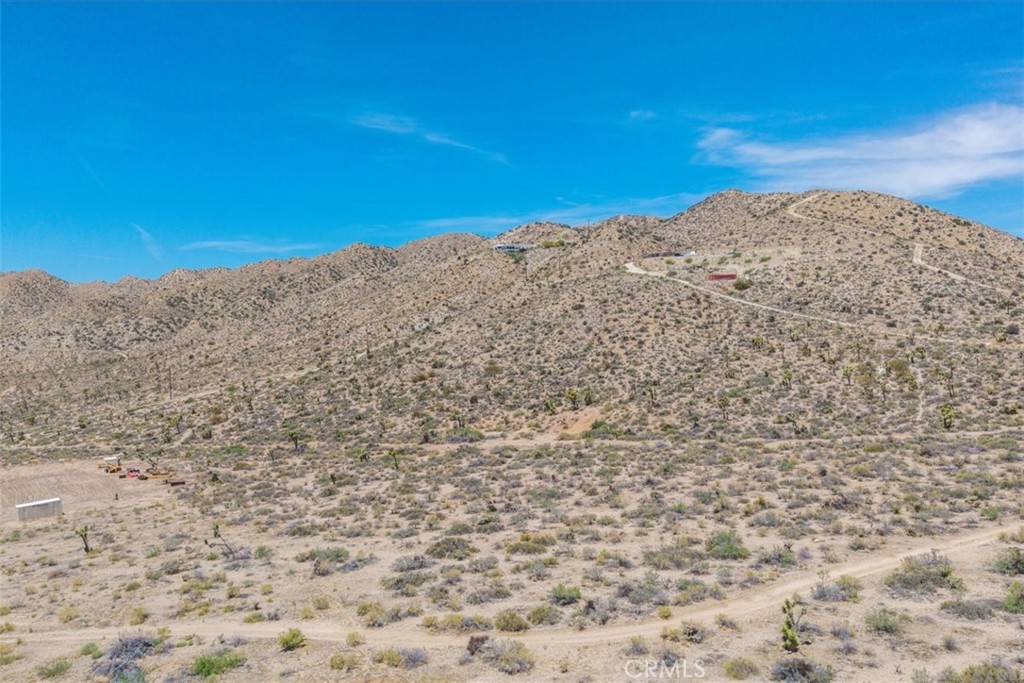 Expansive desert skies, beautiful Joshua Trees, and long views define this 2.5-acre parcel in one of Yucca Valley’s most desirable neighborhoods. The land offers a sense of quiet and space, just minutes from everyday amenities and a short drive to the hiking trails of Joshua Tree National Park, the arts scene of Joshua Tree Village, and live music at Pappy & Harriet’s in Pioneertown. Joshua Trees dot the property, adding natural beauty—buyers should consult with the Town of Yucca Valley regarding any building restrictions related to tree preservation.