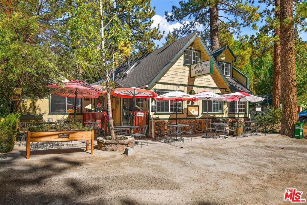 Incredible mixed use opportunity for an owner-investor! Live in a beautiful 1,200 sq foot home attached to a cafe in the up and coming North Shore of Big Bear Lake, California. The North Shore Cafe has been a successful mainstay restaurant for 3 decades. This is your opportunity to take over a wonderful local cafe or turn it into the restaurant/small business you've always dreamt of. For the price of one single family residence, you get a home, a fully equipped restaurant, and a proven track record. The 3 bedroom + 2 full bathroom attached home is move-in ready with the kitchen being recently remodeled in 2019. On the first floor you'll find an open family room with a cozy fireplace, a separate dining area followed by the remodeled kitchen, a gorgeous full bathroom, and a spacious laundry room that leads to the backyard space. The second floor features a den with a large attached deck that can be used as a bedroom, a spacious en-suite primary suite with an office area, and finally, a third space that can be used as a 3rd bedroom, at-home gym, etc. This charming home is attached to the cafe for ultimate ease of work-life balance with ZERO COMMUTE! The North Shore Cafe seats 40 and has a spacious outdoor patio seating an additional 30 guests. The kitchen is fully equipped with top of the line equipment, including a 72" Royal double range with griddle, large walk in refrigerator, meticulously kept kitchen, 8 foot stainless prep and sink area with an additional prep room complete with sink, counter space, and an additional refrigerator which leads to an over 200 sq ft storage room equipped with shelving units and plenty of space to keep all backstock organized. You don't want to miss out on this rare opportunity to own and operate a successful cafe in Big Bear Lake and live in the convenient and charming attached home. Alternatively, you can rent the home or have a chef live in the home - make it what you want!