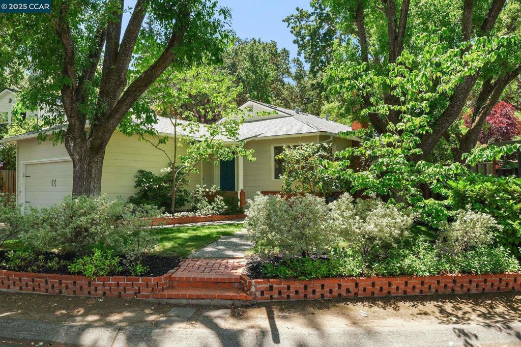 OPEN SAT/SUN July 26/27, 1-4. SUPER CUTE NEW LISTING in Parkmead NEAR TOWN! This 3bd/2b storybook home maintains its original charm but has been expanded with a new primary suite and an additional living room just off the kitchen that opens to the fabulous rear yard. Both additions offer vaulted ceilings and ample windows for excellent natural light and views of the home’s beautiful and very private setting. The home has been refreshed with new paint inside and out, new flooring in the primary bedroom and rear living room, and has an owned solar system! The home retains its original hardwood floors, which can be refinished in the stain color of your choice, if desired. The grounds are landscaped with a variety of low-care perennials, and beautiful mature trees, including fruit trees, oaks, Japanese maples and dogwood. And the icing on the cake is the surprise you’ll find as you step through the rose arbored gate in the rear: There’s an expansive 6000 square feet of land ready for additional gardening, a large, level play area, a detached office/hobby space, or just an incredibly tranquil space to unwind with views of majestic oak trees to enjoy. The home’s location is just steps to Parkmead Elem and Tice Creek, as well as downtown WC, Las Lomas High, freeway access and BART.