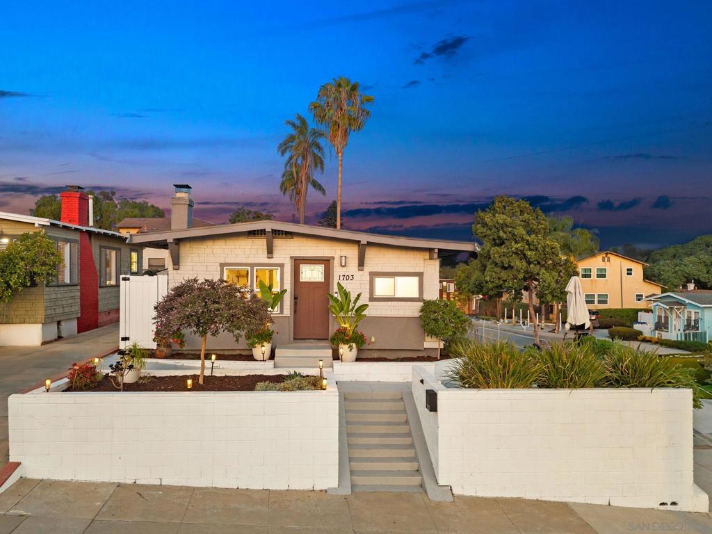 Perched on an elevated corner lot, this 1914 Craftsman blends historic character with modern luxury in one of San Diego’s most beloved neighborhoods. Just a one-minute walk from South Park’s charming cafes, award-winning restaurants, boutique shops, and tree-lined streets, the location alone is a dream. Add in a meticulous top-to-bottom remodel, and this home offers the rare combination of timeless architecture and turnkey living. Step inside to a spacious living room filled with natural light, anchored by a grand fireplace framed with custom built-ins. Original architectural details are celebrated while enhanced with thoughtful updates that make the home both functional and beautiful. The open layout leads into a completely reimagined kitchen, where stainless steel appliances, quartz countertops, and sleek cabinetry are paired with warm accents that honor the home’s roots. A built-in breakfast nook adds charm and makes for the perfect morning retreat. The primary suite feels like a private sanctuary. A custom walk-in closet provides ample storage, while the spa-inspired en-suite bathroom impresses with dual sinks and a stunning curbless shower that highlights the space. Additional bedrooms provide flexibility for family, guests, or a dedicated home office, offering comfort and versatility throughout. The backyard is a highlight of this property, designed for both relaxation and entertainment. Enclosed for total privacy, it features a large grassy area for play, a dedicated outdoor dining space, and multiple seating areas ideal for gatherings under the stars.
