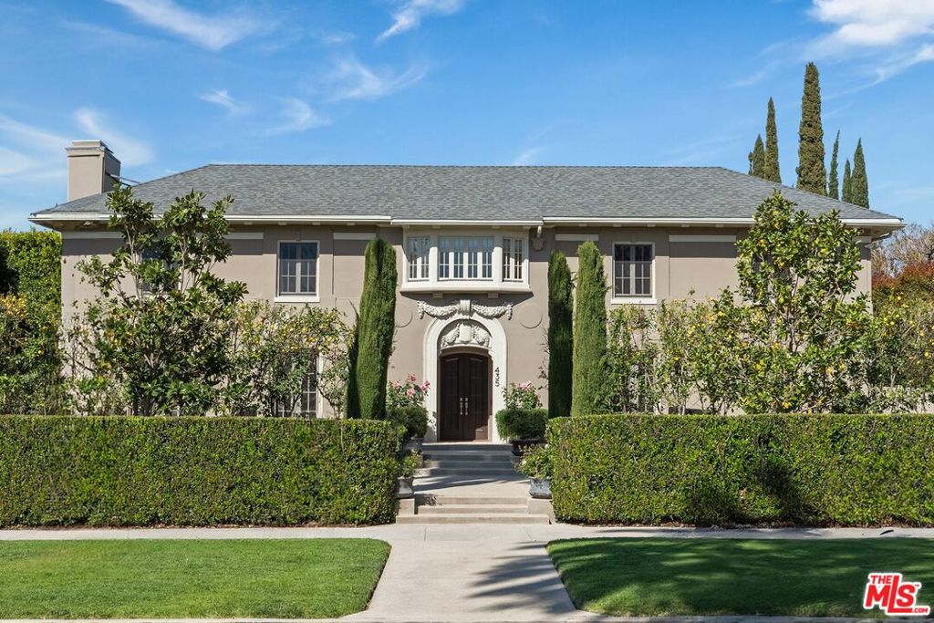 Reduced $1.4m! The best deal around is priced to sell now! Stunning Traditional Windsor Square Estate located on a prime tree lined block within a short distance to Larchmont Village. Beautifully updated for today's living in every way with a Crestron smart home system to control all lights and media. Gorgeous original details include a unique barrel ceiling, incredible intricate crown moldings, wood panels, custom millwork details, marble fireplaces, hardwood floors, french doors and more. Great floorplan with elegant living room, spectacular library/office, and a formal dining room that opens to a hidden speakeasy bar. The family room features a fireplace and a wall of newly-installed steel windows & doors all opening to the terrace and lush grounds. The huge chefs' kitchen with butler's pantry and large breakfast area open to a wonderful outdoor dining area with grill and pizza oven. The second floor has an upstairs deck, a spacious family lounge area and a generous primary suite with beautiful dual baths and walk in closets. A second primary guest bedroom with ensuite bathroom plus new laundry room with double washers and dryers. Two additional upstairs guest suites connect with a jack and jill bath with a stunning skylight. The subterranean level features a gym, full bath, a second laundry room and great storage. The gorgeous manicured grounds feature specimen trees, expansive lawn, sculpted privacy hedges, large swimmers' pool/spa, fountains, a covered loggia with fireplace, mature rose bushes, lemon trees and more. A charming separate guest house is above the garage with a kitchenette, bath, fireplace and private laundry. Don't miss this very special, impeccably maintained Hancock Park residence minutes from the Grove, shopping and great restaurants.