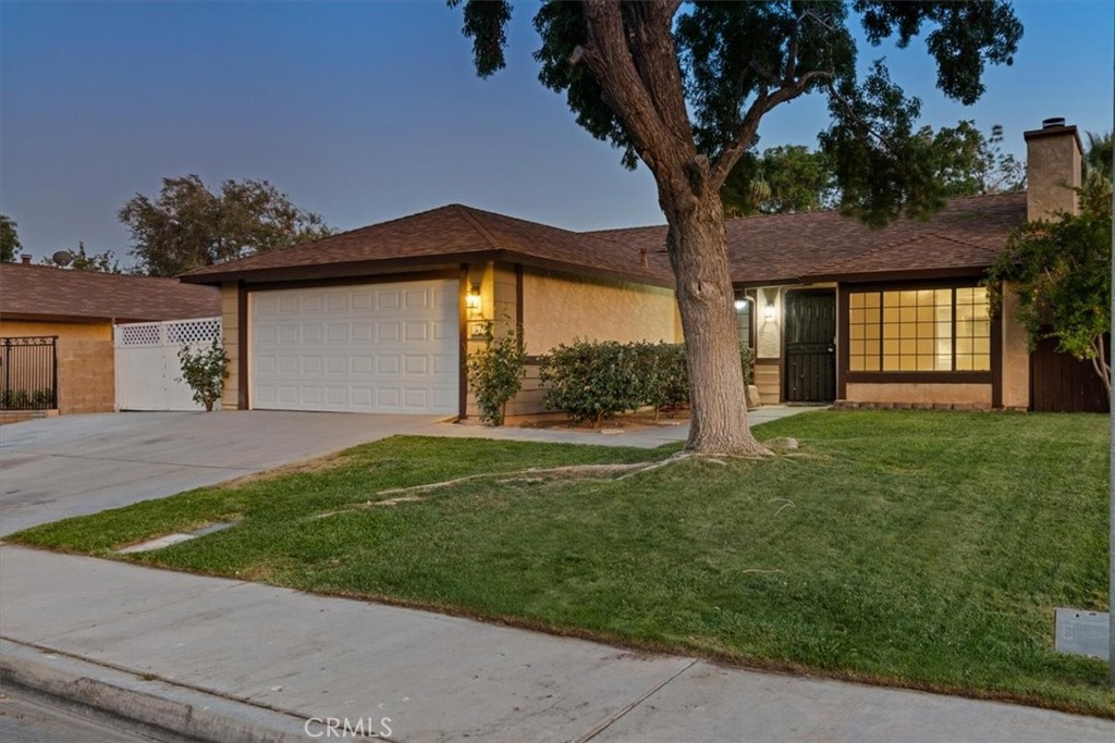 Updated and move-in ready! This West Lancaster single-story has unbeatable convenience. Inside, enjoy brand new flooring, fresh paint, a bright open layout, and a cozy brick fireplace in the living room. New kitchen appliances, new bathroom light fixtures and toilets, and ceiling fans throughout. The kitchen offers convenient cabinet space and a functional design that's perfect for everyday living. Outside is where this home shines—full RV access with hookups that can fit up to a 40-foot-long fifth wheel, a wide driveway for extra parking, and a huge backyard designed for relaxation and play. Mature fruit trees, tiered planters such as fig, yellow peach, apple, cherry, white peach, grape trees, lavender, pomegranate, and pineapple guava, all growing near a lush lawn to create a private retreat you'll love coming home to. All of this in a quiet, established neighborhood just minutes from shopping, dining, schools, and major aerospace employers like Northrop Grumman and Lockheed Martin. Modern updates, big yard, RV amenities—this one has it all!