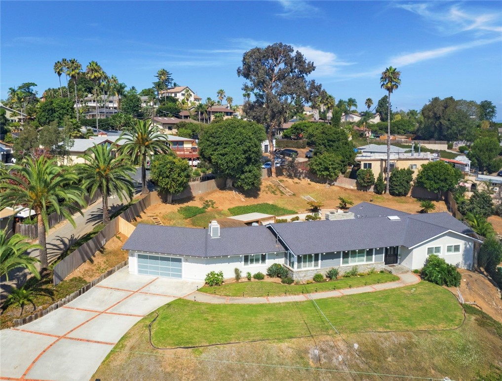 Rare oversized .61-acre lot in the highly sought-after Fire Mountain neighborhood of Oceanside, this beautifully remodeled single-level home offers the perfect blend of comfort, privacy, and coastal living. Recent upgrades include a new HVAC system and new roof . Light-filled floor plan with plank oak flooring, custom doors, wood shutters, and newer windows throughout. The remodeled kitchen boasts an island with skylight, quartz countertops, and stainless steel appliances. The oversized primary suite features a walk-in closet and remodeled bathroom. Additional highlights include three fireplaces, an in-ground spa, and stunning views. Outdoors, the large lot provides endless potential for a guest house, pool, or other additions. The mature landscaping and trees create a serene and private setting, while the long driveway offers ample parking. Easy access for commuting, the beach, shopping, and dining, this Fire Mountain gem combines convenience, beauty, and lifestyle in one incredible property.