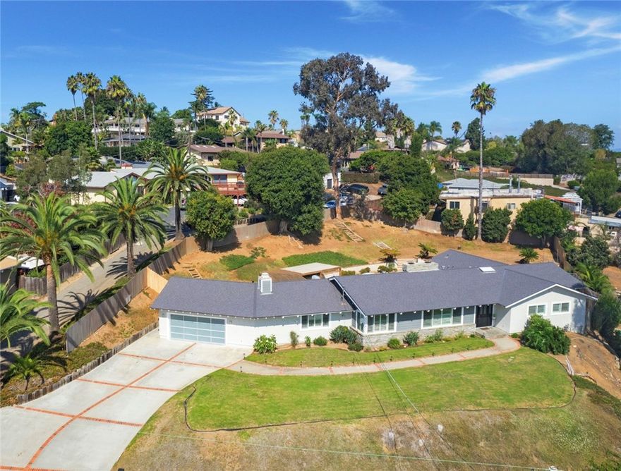 Rare oversized .61-acre lot in the highly sought-after Fire Mountain neighborhood of Oceanside, this beautifully remodeled single-level home offers the perfect blend of comfort, privacy, and coastal living. Recent upgrades include a new HVAC system and new roof . Light-filled floor plan with plank oak flooring, custom doors, wood shutters, and newer windows throughout. The remodeled kitchen boasts an island with skylight, quartz countertops, and stainless steel appliances. The oversized primary suite features a walk-in closet and remodeled bathroom. Additional highlights include three fireplaces, an in-ground spa, and stunning views. Outdoors, the large lot provides endless potential for a guest house, pool, or other additions. The mature landscaping and trees create a serene and private setting, while the long driveway offers ample parking. Easy access for commuting, the beach, shopping, and dining, this Fire Mountain gem combines convenience, beauty, and lifestyle in one incredible property.