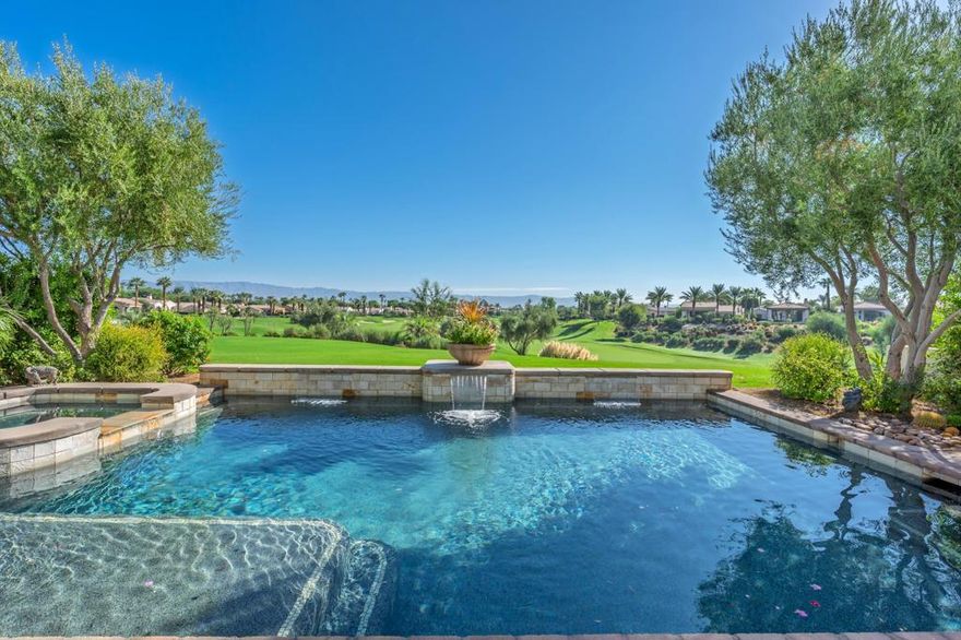 Wake up to breathtaking sunrises and sweeping mountain views across the 2nd green of the Rees Jones designed course in the prestigious Andalusia at Coral Mountain. Enter through a beautifully designed gated courtyard with fountain that sets the tone for this exceptional home. Inside, the spacious open floor plan showcases a gourmet kitchen with granite countertops, stainless appliances, wine refrigerator, dual sinks, abundant cabinetry, and walk-in pantry. The adjoining great room impresses with custom entertainment cabinetry, soaring ceilings, a cozy fireplace, and 12-foot sliding doors that open to an expansive loggia with panoramic views. The primary suite offers a true retreat with expansive vanities, a dual-headed shower, soaking spa tub, and his-and-her walk-in closets. Guests will enjoy the privacy of a detached two-room casita complete with bathroom and sitting room. Outdoors, a salt-water pool with bar seating, raised spa, water features, and built-in BBQ create a resort-style setting perfect for entertaining. Come live the life you've always imagined!