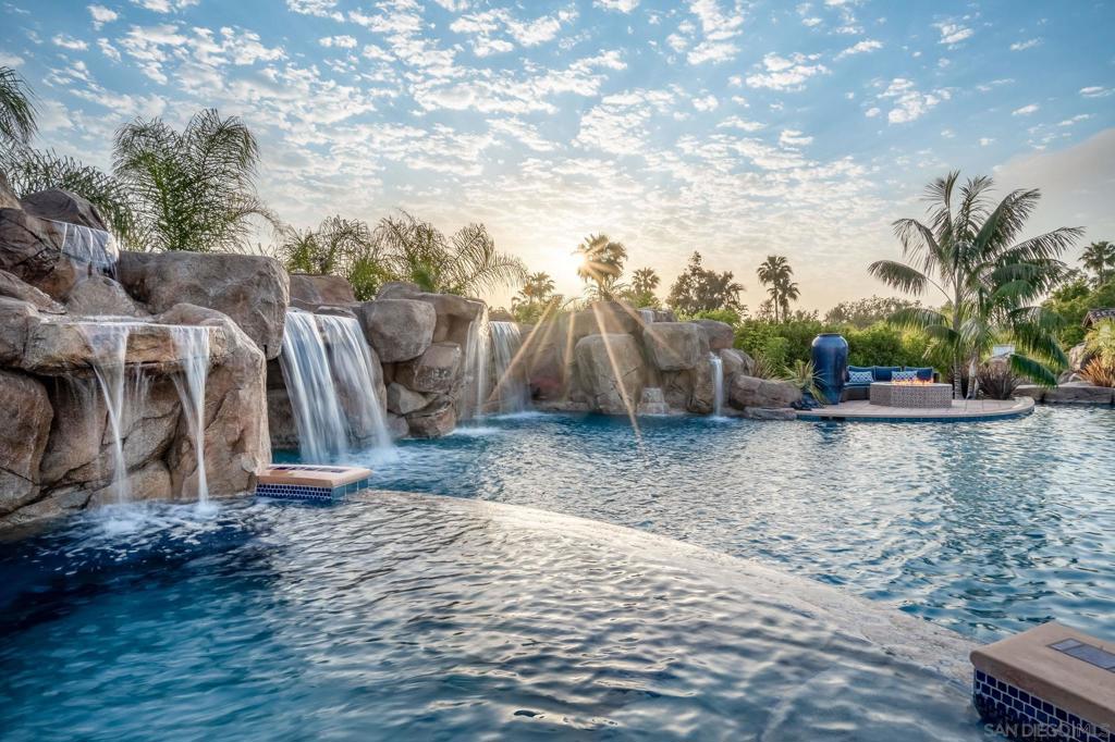 Welcome to your dream estate in Rancho Santa Fe! Set on 4.45 acres, this newly constructed custom home, completed in 2020, offers an incredible living experience with over 22,500 square feet of indoor and outdoor covered spaces. Designed for the ultimate lifestyle, this property has it all. Step into the gourmet chef's kitchen, equipped with a walk-in freezer, perfect for hosting and entertaining. Enjoy leisure and fun with a two-lane bowling alley, a 780-square-foot private gym, and a top-of-the-line movie theater for viewing. Let your creativity flow in the dedicated crafts room. The estate also features a large bar area, a sophisticated cigar and wine room, and an amazing outdoor kitchen with a swim-up bar, making it ideal for gatherings. The property includes a 2-bedroom, 1,222-square-foot detached guest casita, offering a comfortable retreat for guests. Two wells ensure the lush landscaping stays vibrant year-round. This estate truly offers a unique opportunity to enjoy luxury living in the beautiful surroundings of Rancho Santa Fe. Don't miss out on this exceptional property!