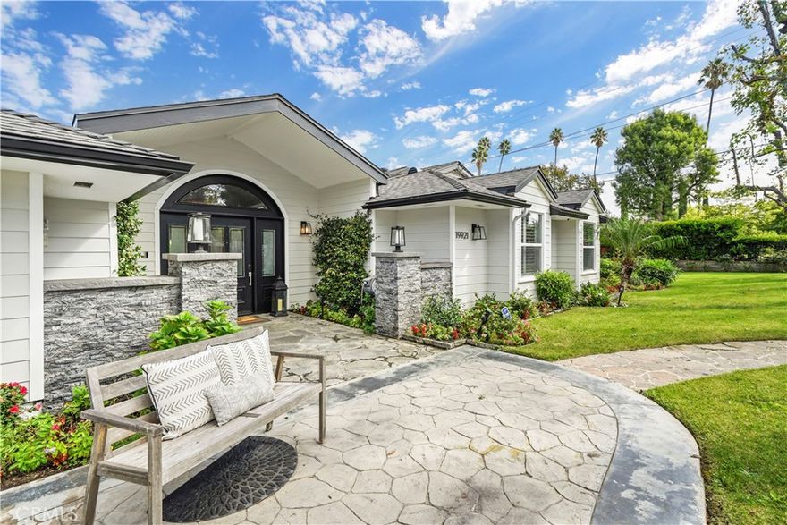 South of the Boulevard, this sprawling single-level estate sits on a magical corner lot, offering over 4,600 sq. ft. of living space on nearly half an acre. A private 1-bedroom, 1-bath guest unit with its own kitchen and separate entrance adds versatility for extended family, guests, or office use. Behind decorative gates, the home welcomes you with a stamped concrete driveway, park-like grounds, and mature trees. Inside, expansive windows draw in natural light, highlighting vaulted ceilings, recessed lighting, and beautiful hardwood flooring. The open chef’s kitchen is the heart of the home, featuring A-frame ceilings, a large center island, granite counters, custom cabinetry, stainless steel appliances, and a walk-in pantry. The spacious primary suite includes vaulted ceilings, a generous walk-in closet, and a luxurious marble-adorned bath with spa tub and separate shower. Four additional bedrooms, a living room, and a family room provide ample space for comfort and entertaining. Outdoors, enjoy a gated pool and spa, large grassy yard, and dedicated dining/entertaining areas. Located within the highly regarded Wilbur Elementary school district, this home offers an exceptional leasing opportunity not to be missed.