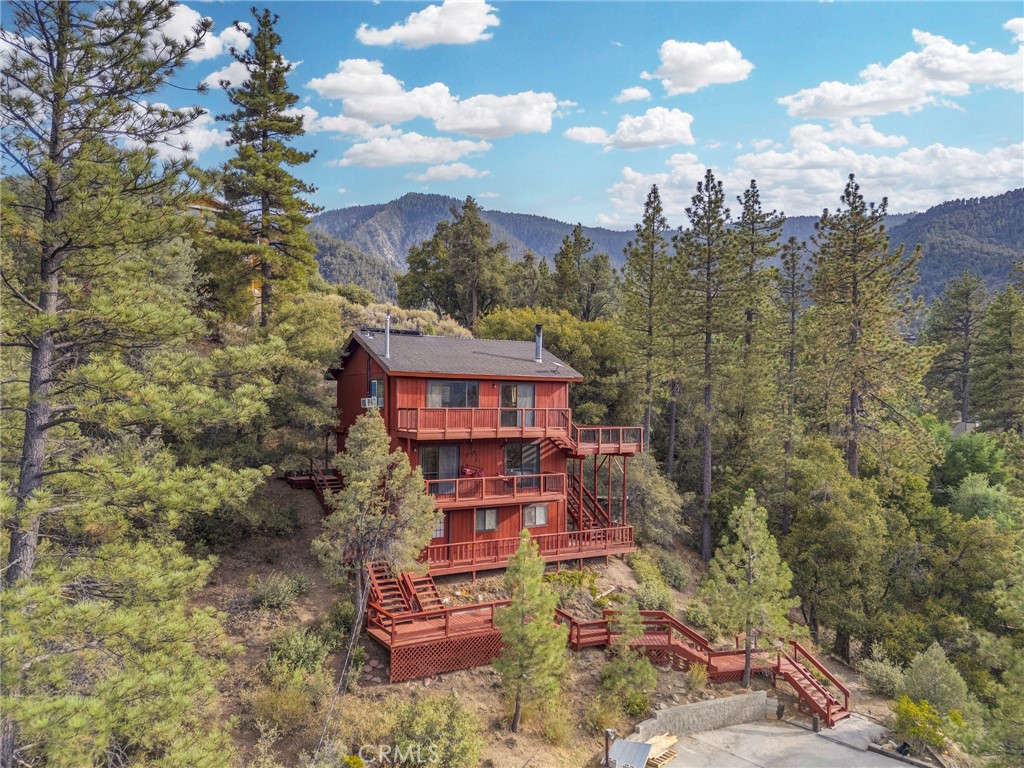 Perched high above Pine Mountain Club, 16000 Zurich Way is more than a home—it’s a 1,344 sqft, 3-bedroom, 2-bathroom sanctuary that feels like an adult treehouse cradling the heart of the San Emigdio Mountains. This cabin, with the finest views in the community, invites you to live where sunrises spark hope and sunsets weave dreams, each moment framed by nature’s boundless beauty.
Step inside, and the story unfolds across brand-new luxury plank flooring that flows seamlessly through every room, grounding the home in modern elegance. The top-floor living room, a haven of light and air, opens to decks where the mountains seem close enough to touch. A Vermont Castings wood-burning stove glows with efficient warmth, perfect for crisp evenings, while new security-screened doors invite cool breezes. A plush, rearrangeable Lovesac couch and a pivoting Samsung Frame TV set the stage for cozy nights or lively gatherings, all bathed in the glow of updated lighting.
Downstairs, the living quarters hum with comfort. The primary suite, with its Dreamcloud king bed, offers restful retreat, while two additional bedrooms with twin beds welcome guests or quiet reflection. A convertible standing desk in the office fuels inspiration, and a Nordictrack treadmill with an iFit screen lets you chase virtual trails from the comfort of home. The kitchen, alive with modern LG appliances, centers around a locally crafted pine table, ready for shared meals or morning musings. A new LG washer and dryer, plus a portable AC unit, keep the lower level practical and cool.
This cabin’s soul lies in its setting and spirit, not just its thoughtful furnishings. Pine Mountain Club wraps you in community—a heated pool, golf course, clubhouse, and village center, all under 24/7 patrol—yet the home itself is the star. From the unfinished storage space below to the breathtaking views above, every detail whispers possibility. At 16000 Zurich Way, you don’t just find a house—you discover where your story belongs.
Schedule a private tour to claim this mountain masterpiece today.