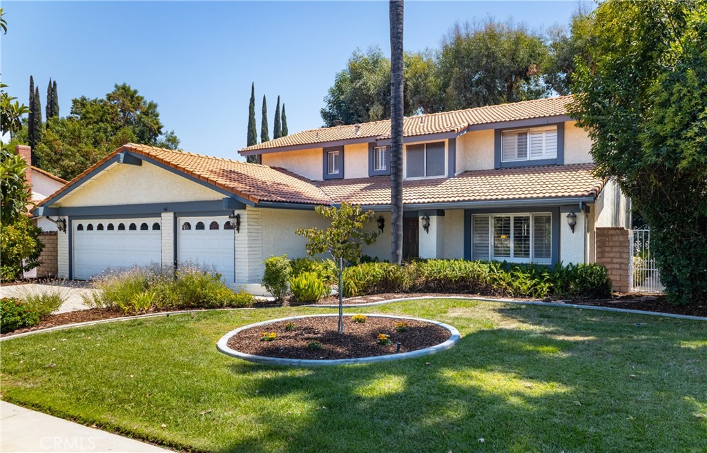 VOILA! This beautiful 5 bedroom, 3.5 bath home offers the perfect blend of togetherness and privacy. Designed for versality, it features a
MULTI-GENERATIONAL APARTMENT, (built in 2014) on the main floor, with its own private courtyard entrance and convenient interior access to the main home. The apartment, or Guest Suite includes a spacious living area with kitchenette, separate bedroom with huge walk in closet and bathroom with a real walk-in or wheel chair accessible shower! This space is ideal for extended family or guests, OR your own getaway!! The owner spared no expense with having this apartment built for her mother so please note the kitchenette with attractive wood cabinets and granite counters, plus the huge vaulted ceiling and recessed lighting. It does have its own split heating/air system and shares other utilities. Situated in a desirable neighborhood, close to schools and shopping, this home offers flexibility for every stage of life and space for everyone. The main home formal entry beckons you into a nice open large living room and spacious dining room with view out to the patio and green space. The kitchen with granite countertops and stainless steel appliances has a breakfast nook that opens up to the family room with fireplace, wet bar and a wall of built in book shelves, plus a great view of the very private patio with built in spa! The sliding glass door provides easy access from breakfast nook to the patio for outdoor entertaining. Fruit trees? Yes! Fig and Lemon. The 3 car garage gives direct access to the home. The downstairs guest half bathroom is in the hallway before entering the stairwell. Upstairs are 4 bedrooms, including a large primary suite with two separate sinks and large remodeled shower. The other 3 bedrooms and full bathroom are generous and designed for family living. Note that the windows in the entire home has plantation shutters. This home is a winner!