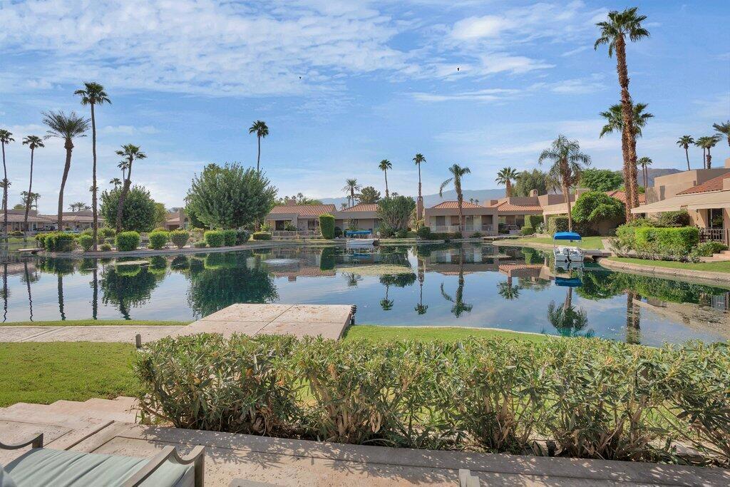 Lake Mirage is a fabulous community with just 238 homes/condos. This spectacular condo is 2625 sq. ft. with 2 primary suites with oversized bathrooms. Each bath has soaking tub, nice shower, double sinks and a separate toilet area. From the entry, step down into the living room that is very spacious with a fireplace and a wet bar. You can entertain your family and friends on the beautiful patio on the water or down on the dock. The community allows small electric boats on the lake or you can take a kayak or canoe out there for some great exercise! The condo has an attached 2 car garage with direct access into the home. There are 11 pools, 10 tennis courts and 4 pickleball courts. They have a clubhouse that you can use for meetings or a special occasion. Come take a look at this fabulous, spacious home.