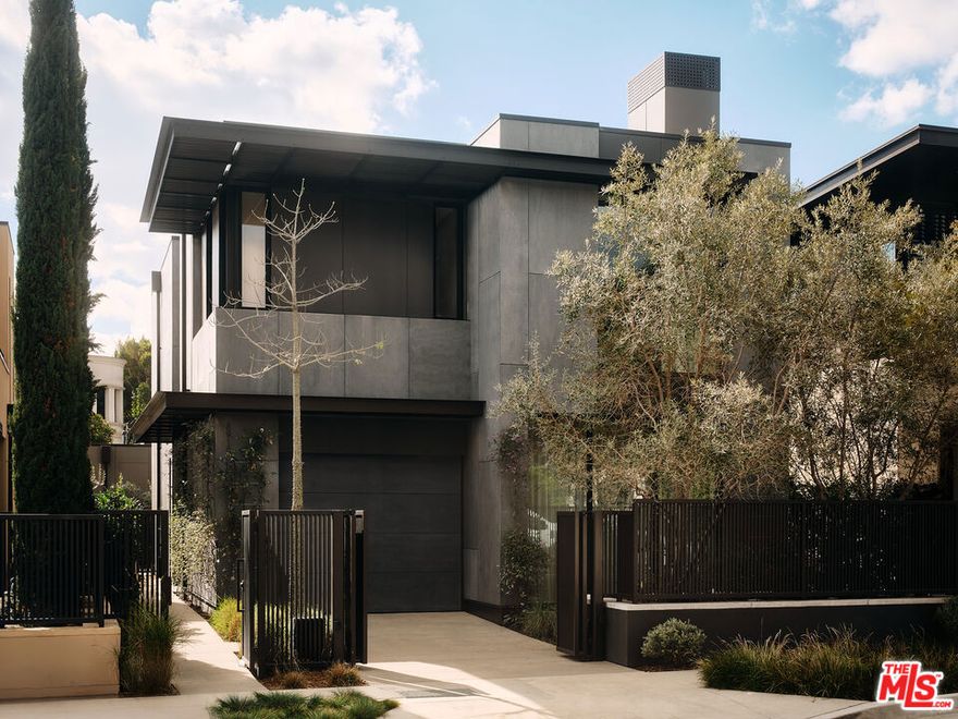 Garden House.Olson Kundig.  Nestled in the heart of West Hollywood, 8910 Rosewood Avenue embodies luxury living, where resort-style amenities merge seamlessly with architectural brilliance. This remarkable residence is part of an exclusive collection of eight signature homes designed by the world-renowned Olson Kundig, each offering a distinct material palette and a truly unique living experience.  Garden House is a masterpiece of lightness and fluidity, thoughtfully divided into north and south zones to create a dynamic spatial experience. The 3,067-square-foot main residence features three bedrooms and three-and-a-half bathrooms, complemented by an additional studio house with its own bathroom. Entering through the side, guests are welcomed into a harmonious interior progression that effortlessly connects both zones. At the heart of the home, a grand double-height central space and an inviting fireplace in the living room unify the interiors, enhancing the sense of warmth and openness.  True to its name, Garden House epitomizes indoor-outdoor living, seamlessly integrating elegant interiors with serene outdoor spaces. Multi-panel operable doors in the front living and rear dining rooms invite effortless transitions between indoor comfort and outdoor hospitality. A private garden sanctuary awaits, complete with a tranquil plunge pooloffering a retreat of unparalleled serenity.  Residents of this signature collection enjoy a perfect balance of individuality, privacy, and world-class amenities. As part of Olson Kundig's visionary development at 8899 Beverly Boulevard, hailed as a "Love Letter to Los Angeles", homeowners have access to 24-hour concierge services, a state-of-the-art fitness center, and a lushly landscaped oasis featuring a resort-style pool, spa, custom outdoor kitchen, and the acclaimed on-site restaurant, Stella.