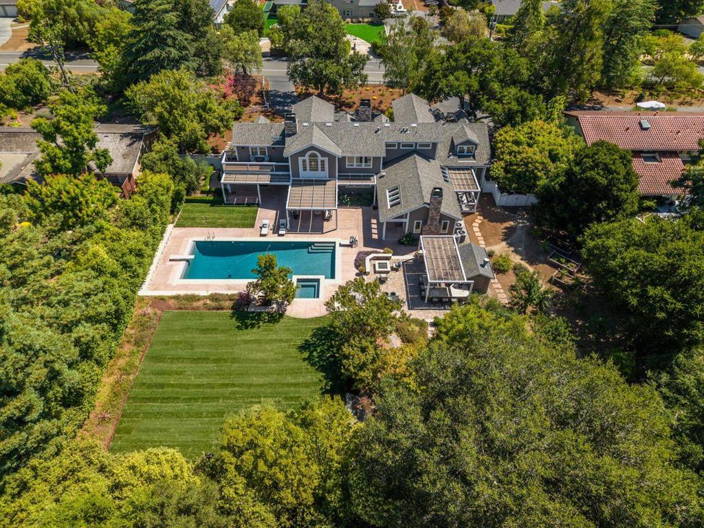 Discover a rare opportunity to own an expansive private estate in one of Silicon Valleys most desirable residential neighborhoods. Set on over 43,000 square feet of level grounds, this thoughtfully maintained property offers the space, privacy, and lifestyle that are increasingly hard to find. Step through a dramatic two-story, northeast-facing entry to find soaring ceilings, artisan details, and sunlit interiors that open seamlessly to the outdoors. The luxurious home includes formal living and dining rooms, a chef's kitchen with Sub-Zero and Viking appliances, and a romantic primary suite with a sunset deck and spa-inspired bath. Guests will appreciate two private suites on the main level. Mature landscaping surrounds a private pool, FireMagic outdoor kitchen, an orchard, and raised garden beds, perfect for entertaining and relaxation. Located approximately two blocks from Pinewood School and within the acclaimed Los Altos Elementary and Mountain ViewLos Altos Union High School Districts, this address also offers convenient access to Downtown Los Altos Village. The area is known for its farmers markets, live music nights, festive parades, and vibrant year-round community events. Experience the privacy, space, and community spirit that make Los Altos truly unique.