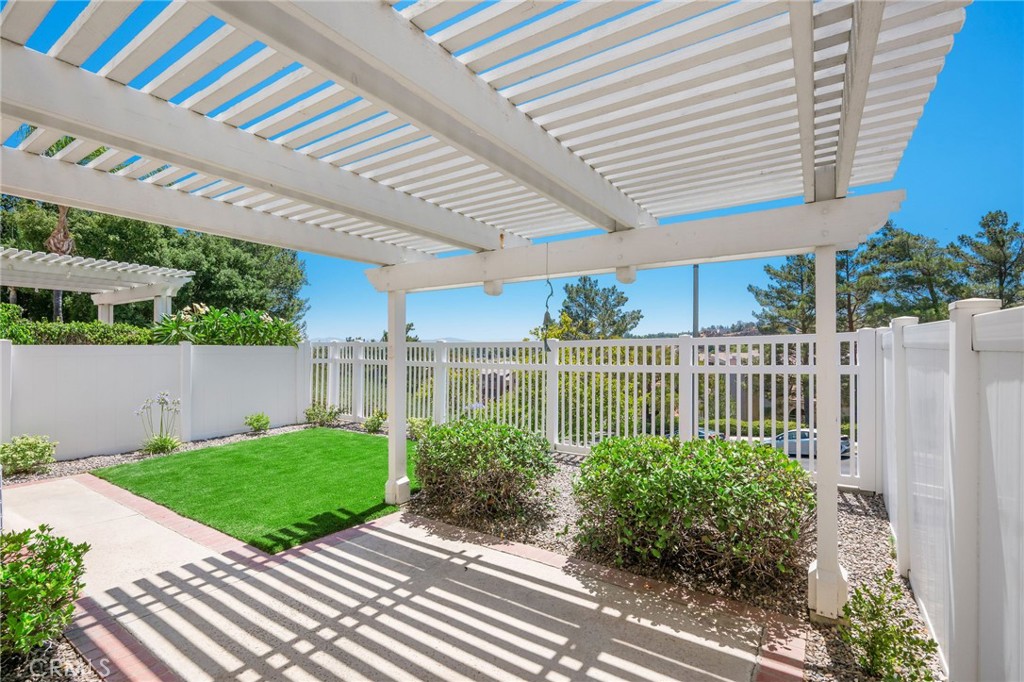 Welcome to Bella Vista, a peaceful and beautifully maintained community nestled in the hills of Sierra Del Oro, offering a commuter’s dream location with easy access to Orange County and Palm Springs. This former model home, part of an exclusive enclave of only 72 residences, has just undergone a stylish turnkey refresh with brand new paint, plush carpet, and sleek new appliances—ready for you to unpack, unwind, and make it your own with a floorplan designed for California living. Step through the front door and into soaring ceilings, fresh paint, brand-new carpet, and warm tile floors that lead you through a formal living and dining space filled with natural light. A cozy fireplace anchors the living room, while built-in cabinetry and granite countertops make the adjacent kitchen very functional. New stainless-steel appliances and a breakfast peninsula offer a perfect spot for casual morning coffee or entertaining friends and family. From both the living and dining rooms, dual-pane sliding glass doors open to a private backyard that feels like your own little oasis. Newly landscaped with lush artificial turf and low-maintenance drought-tolerant plants on a drip irrigation system, the space is perfect for kids, pets, or simply enjoying your morning coffee while watching the sun rise over the mountains. String up the café lights, fire up the grill, and dine al fresco under the covered pergola. The floorplan offers flexibility for all stages of life, with a full bedroom and bathroom conveniently located downstairs. Upstairs, the spacious primary retreat features vaulted ceilings, dual closets, and a spa-like ensuite with dual vanities, shower/tub combo, and a built-in bench. The third bedroom includes its own ensuite and ample closet space, making it an ideal second bedroom. Major upgrades include brand-new PEX plumbing throughout with a full warranty, ensuring peace of mind for years to come. The community HOA maintains the exterior, front landscaping, and includes access to the community pool and spa—perfect for relaxing after a weekend hike along nearby Skyline Trail. Commuters will love the easy access to the 91 freeway, 241 toll road, and the 15 freeway—whether you're headed into Orange County or escaping to Palm Springs for the weekend. Plus, with shopping, parks, and a California Distinguished School nearby, this location offers the lifestyle you’ve been searching for. This move-in-ready gem is more than just a house—it’s a place to call home.