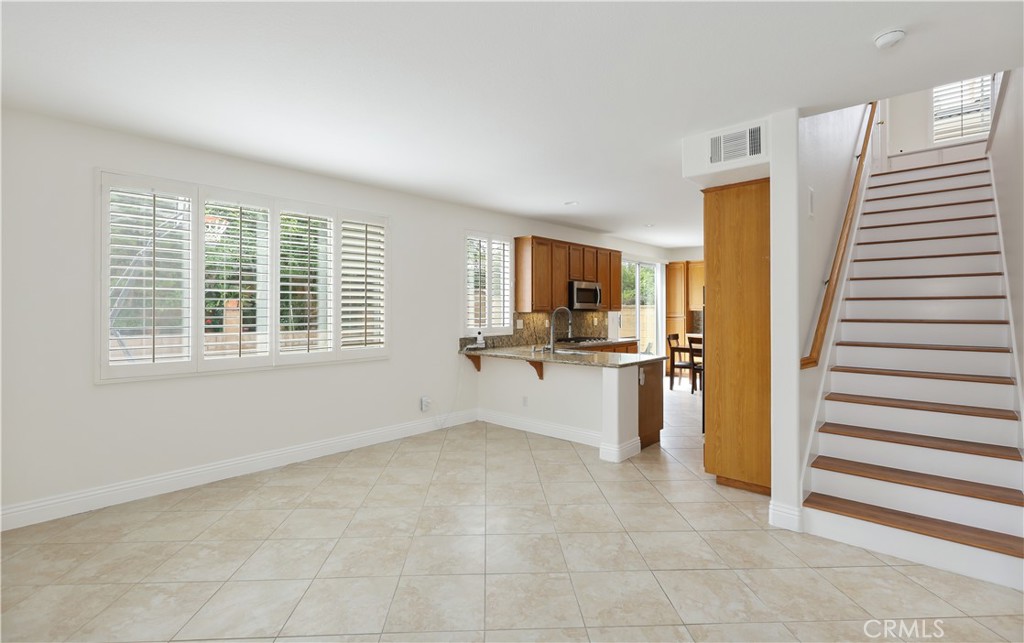 This beautiful 4-bedroom, 2.5-bath home sits on a desirable corner lot and offers plenty of space and natural light. Enjoy a spacious living room and a separate family room with tile flooring— perfect for both relaxing and entertaining. The gourmet kitchen features granite countertops and is ideal for home chefs. The large master bedroom provides a private retreat, and the spacious backyard offers endless possibilities for outdoor fun, gardening, or future additions. Bright and inviting, this home is filled with sunshine. Tesla Charger in the Garage.
