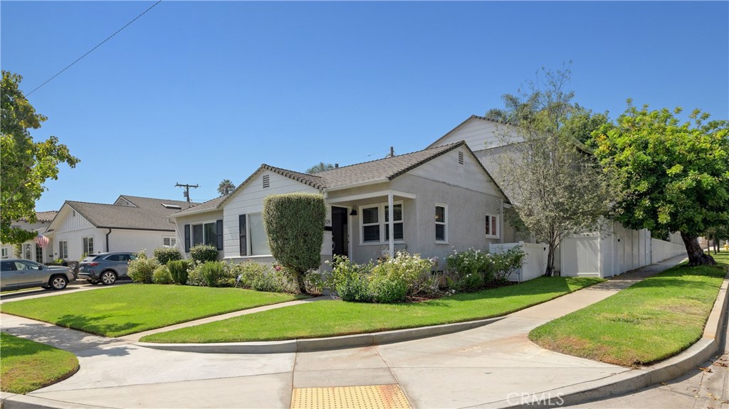 Welcome to this beautifully updated 4-bedroom, 2.5-bath residence in the highly sought-after Liberty Village neighborhood of Manhattan Beach. With over 2,300 sq. ft. of thoughtfully designed living space, this home blends timeless charm with modern comfort. Set on a desirable corner lot, the home offers fantastic curb appeal with lush landscaping and a welcoming front porch. Inside, you’ll find a light-filled floor plan featuring two spacious living areas, custom built-ins, and elegant finishes throughout. The remodeled kitchen boasts crisp white cabinetry, quartz countertops, stainless steel appliances, counter seating and dining nook area—perfect for both everyday living and entertaining. The primary suite provides a serene retreat that occupies its own level, offering high-ceilings, a walk-in closet, and a luxurious en-suite bath with dual vanities and designer finishes. Three additional bedrooms in the home offer flexibility for family, guests, or a home office. The rear living area boasts a fireplace, custom cabinetry, wet bar and accordion sliding doors that lead to the backyard and patio. Outside, enjoy a private yard ideal for relaxing, gardening, or hosting gatherings. The custom "Garage Envy" garage includes epoxy floors and built-in cabinets. Located on a wide, tree-lined street, this turn-key home offers charm, space, and close proximity to award-winning Manhattan Beach schools, Polliwog Park, shopping, dining, and the beach, this property offers the best of South Bay living!