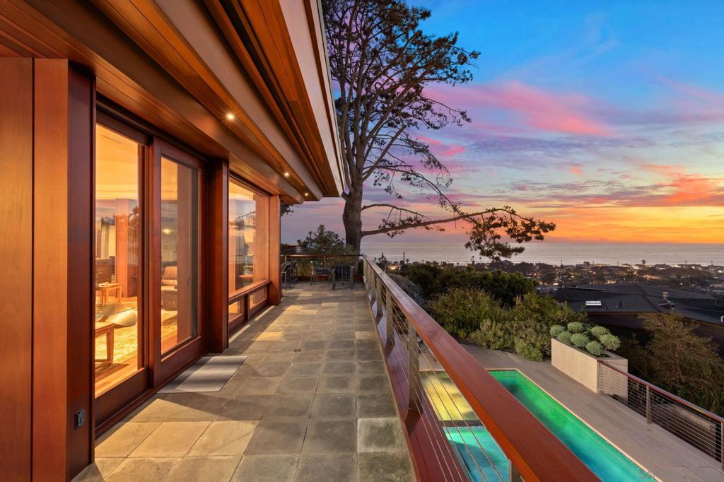 Making Waves ~ A rarely available Old Del Mar view home of this caliber, offering jaw-dropping panoramic Ocean Views. Walls of glass and wraparound view decks seamlessly blend indoor-outdoor living. Built by Wardell Builders, the 3+ BR home draws inspiration from Cliff May’s iconic California modernism, with exposed beams, natural materials, and a seamless connection to light, land, and sea. Elevated above the coastline on a prime hillside lot, this solar-powered residence is designed for both full-time living and an effortless lock-and-leave lifestyle. The thoughtfully designed layout includes a chef’s kitchen with honed natural stone countertops, custom cabinetry in a rich, warm finish, chef-grade appliances, a large sink, and built-in ice maker. Designer lighting, a media/game lounge, fully integrated Savant home automation, Lutron, surround sound, security system, and app-controlled pool and spa. The primary suite is a true sanctuary, framed by chic poured in place concrete walls, rich wood accents, and floor-to-ceiling glass that opens to dramatic ocean views. The spa-like bath features warm stone finishes, dual vanities, and a walk-through rain shower. From upper-level view decks to shaded poolside lounges, the home's resort-inspired outdoor living features private pool w/ automated cover and heated spa for year-round enjoyment, surrounded by curated native landscaping and softened lighting. Situated in Old Del Mar, one of San Diego’s most exclusive coastal enclaves, and just minutes from fine dining, shopping, golf, and award-winning schools