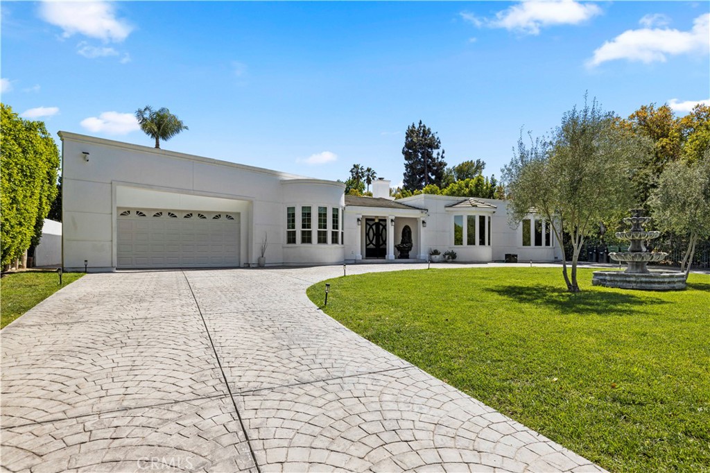 Welcome to your dream home in the highly sought-after Sherwood Forest neighborhood of Northridge! This stunning single-story estate has undergone major renovations in 2024 and is ready to Impress. With 4 spacious bedrooms and 4 luxurious baths, this gated pool home sits on a large private lot, offering both tranquility and room to entertain. Step inside to discover exquisite upgrades, including Milgard Tuscany windows and doors that bathe the home in natural light. The elegant plank flooring adds warmth and style, while the beamed ceilings in the living room and master bedroom create a cozy yet sophisticated atmosphere. The heart of this home is the open-concept kitchen, which seamlessly flows into the living room. It features sleek new cabinets, an oversized center island with a convenient prep sink, and top-of-the-line appliances, including a Subzero Pro 48" refrigerator and Wolf dual 6-burner oven. A wine fridge completes this culinary paradise, perfect for hosting gatherings or enjoying a quiet night in. Other standout features include two tankless water heaters, a whole house filtration system and beautifully renovated bathrooms throughout. The primary suite is a true retreat boasting a cozy fireplace and loft with a balcony that opens and overlooks the backyard and bathroom that is truly stunning with dual head shower and beautiful claw tub. The outdoor space is just as impressive, featuring a gorgeous pool and spa, water falls and pond. The pool home is equipped with new A/C heating, a sliding door that gives you direct access to the pool and a remodeled bathroom. Don't miss your chance to own this exceptional home in Sherwood Forest where luxury meets comfort!