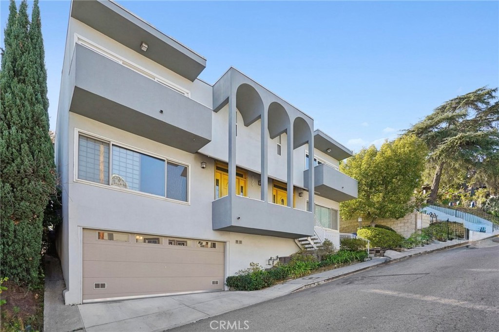 Nestled in the hills this Silver Lake duplex offers incredible potential and unmatched convenience just moments from the best the neighborhood has to offer. Each unit is a mirror image of the other, featuring 3 bedrooms and 2.5 bathrooms, separate dining rooms, and spacious living areas ideal for hosting and everyday comfort. A shared backyard, garage, and laundry room add to the practicality of the layout, while a newer roof installed in 2025 brings peace of mind.
Unit 2305 is currently vacant and ready for a new owner’s vision—perfect for a buyer seeking to renovate, add value, and capitalize on upside potential. Unit 2307, beautifully updated and tenant-occupied, boasts gleaming hardwood floors, plentiful cabinet storage, and stainless steel appliances including a range/oven, refrigerator, and dishwasher.
Outdoors, mature greenery creates privacy and a tranquil atmosphere, while an expansive yard and deck offer inviting spaces to relax, gather, and enjoy abundant California sunshine.
Located within a short stroll of Silver Lake’s most beloved hotspots, this property puts renowned dining and local favorites at your fingertips—Ivanhoe, Burgers Never Say Die, Forage, Salazar, Edendale, and many more. Whole Foods, Constellation Coffee, Silver Lake Coffee, the reservoir, and the dog park are also just minutes away.
Whether you’re an investor or owner-user, this is a rare chance to secure a versatile property in one of Los Angeles’ most desirable and vibrant neighborhoods.