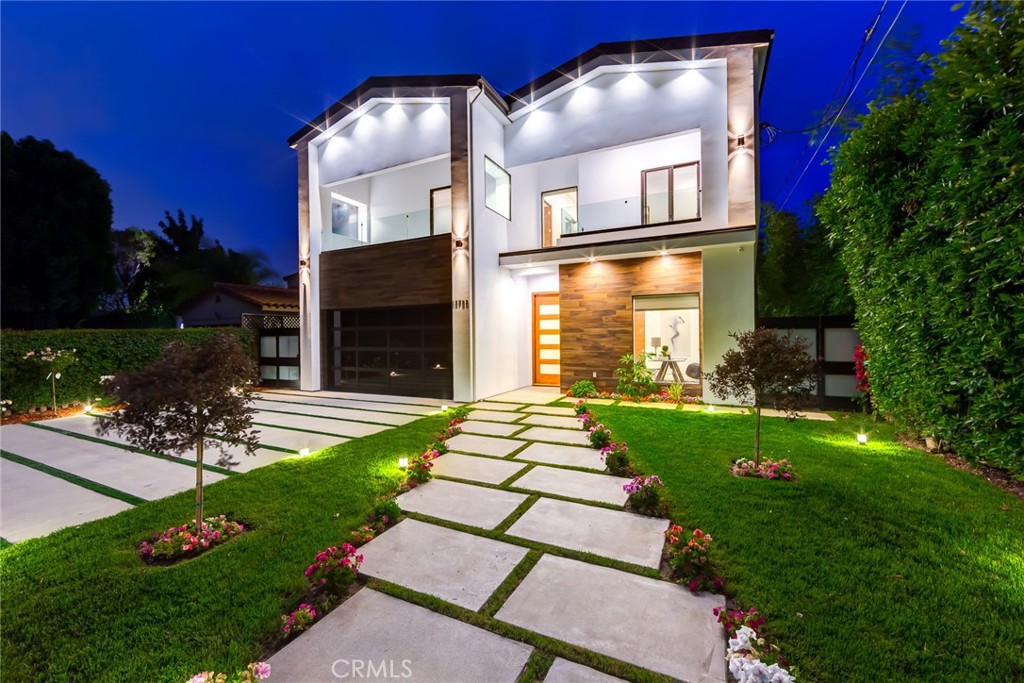 Welcome to this striking architectural gem that blends contemporary elegance with luxury living. Set behind a sleek, gated entrance, this stunning modern home impresses from the curb with its clean lines, wood-accented façade, and bold twin-gable roofline.
Step inside to soaring ceilings, a dramatic floating staircase with glass railings, and expansive open spaces bathed in natural light. The grand entry opens into a sophisticated living area and an entertainer’s dream kitchen featuring top-of-the-line appliances, waterfall island, custom cabinetry, and designer finishes.
Seamless indoor-outdoor flow leads you to a resort-style backyard with a sparkling pool, elevated spa, built-in BBQ, and covered patio – perfect for lounging, hosting, or enjoying tranquil evenings under the stars.
Upstairs, spacious bedrooms offer spa-inspired en-suites and private balconies. The primary suite is a true retreat, complete with a walk-in closet and luxurious bathroom.
Additional amenities include a climate-controlled wine display, smart home features, and secure 2-car garage with ample driveway space.
Available furnished for your convenience.