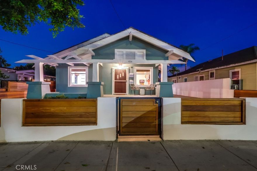 This early-century Craftsman home has been immaculately remodeled and features an accessory dwelling unit (ADU), perfectly situated in the heart of the vibrant "Retro-Row."The home showcases the timeless appeal of Craftsman style with its classic pitched roof, original hardwood floors, unique archways, and double-hanging windows. Upon arrival, the inviting red door and covered front porch set the tone for relaxation—ideal for a porch swing and a morning cup of coffee. Inside, a rustic brick fireplace welcomes you, complemented by abundant natural light streaming through multiple windows. The custom archway leads to a formal dining room, which connects to the kitchen, a cozy breakfast nook, and an additional family room. Both bedrooms are generously sized, with the master suite featuring an expansive walk-in closet to accommodate your storage needs. The long driveway easily accommodates parking for at least four vehicles, ensuring ample space for residents and guests alike.  Out back, you'll find a beautifully landscaped yard perfect for entertaining or relaxing in privacy. Well-manicured lawn and patio space are ideal for barbecues or quiet evenings under the stars. Newly built one-bedroom ADU with dedicated kitchen area provide luxury living or rental income with nicely appointed fit and finishes.