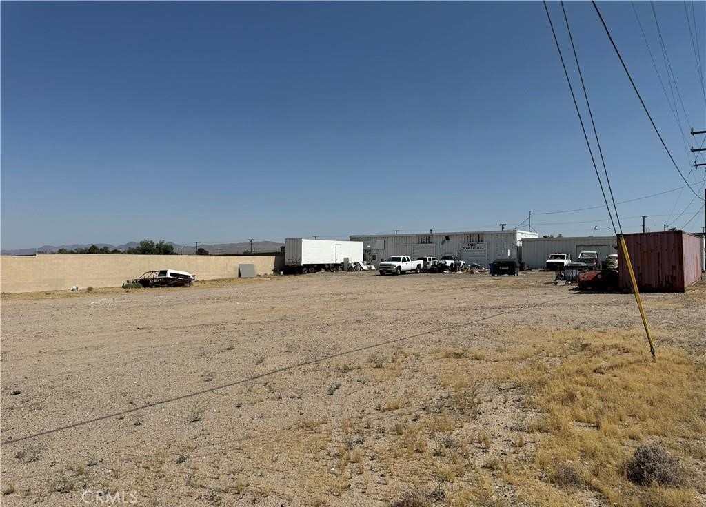 This rare 1.31-acre industrial-zoned property boasts an exceptional location on the I-40 freeway, less than 1,000 feet from the heavily trafficked I-15 freeway. The flat terrain is ideal for various high-demand uses, including truck parking and outdoor storage. Demand for these uses is expected to grow significantly as BNSF advances its $1.5 billion BIG project in the area. This property is unique, both in its potential applications and its prime location