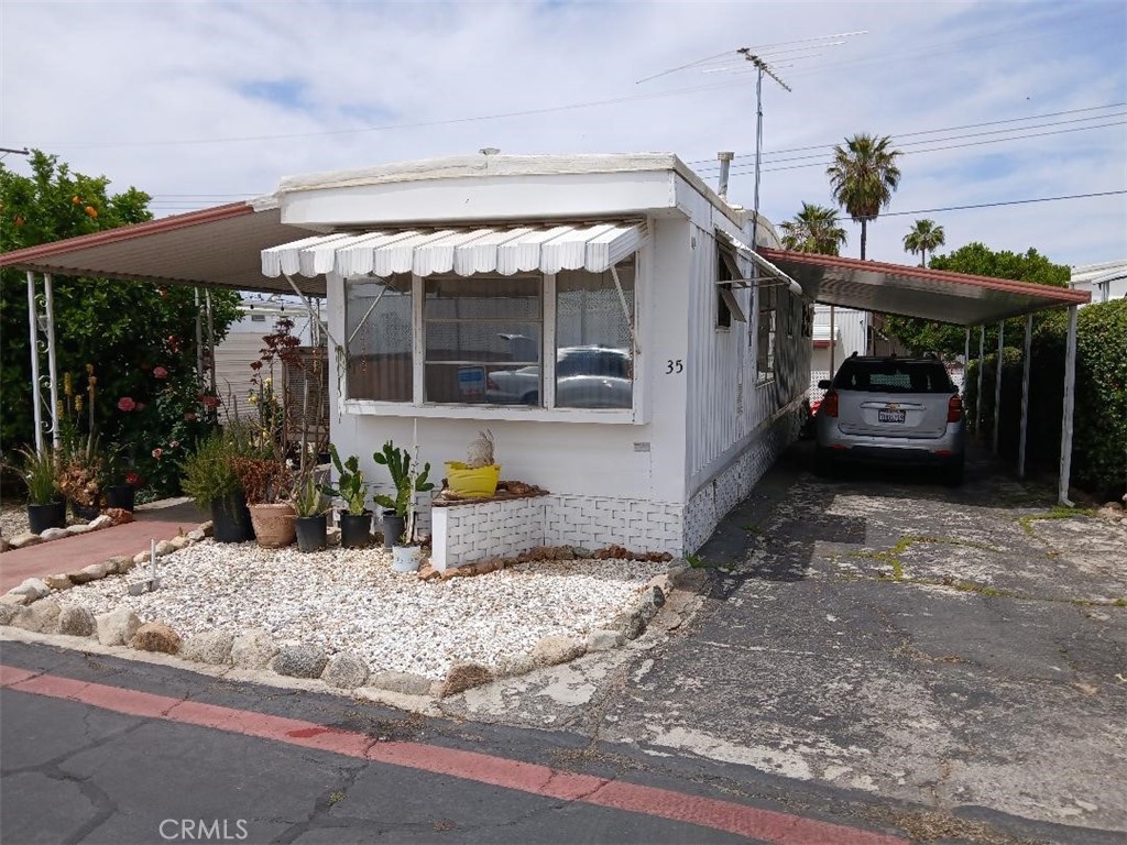 Charming 2 bedroom mobile home, perfect for 55 and over retired couples or singles. Includes enclosed patio for extra space, enclosed utility or laundry room and 2 car attached tantum parking carport. Newer heater, stove top and flooring. Park includes LOW monthly rent space, community pool and private access road into community for residents only. Hurry on this one because these homes don't come up for sale very often in this Bonanza Mobile Home Park Estates.
